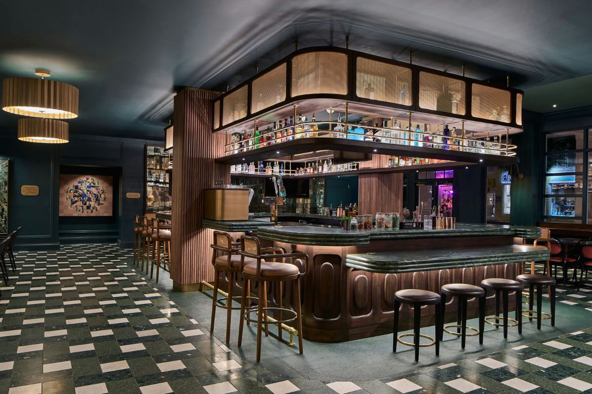 a bar with stools and bottles