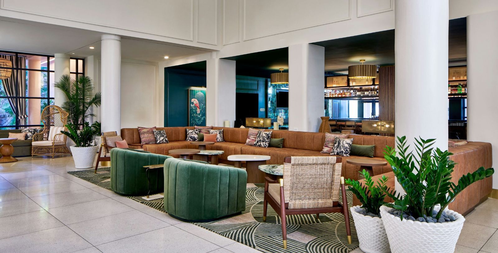a large lounge area with a large couch and chairs