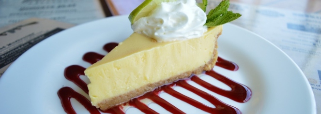 a slice of cheesecake with whipped cream and mint on top