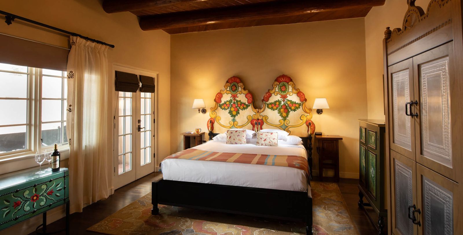 a bed with colorful headboard in a room