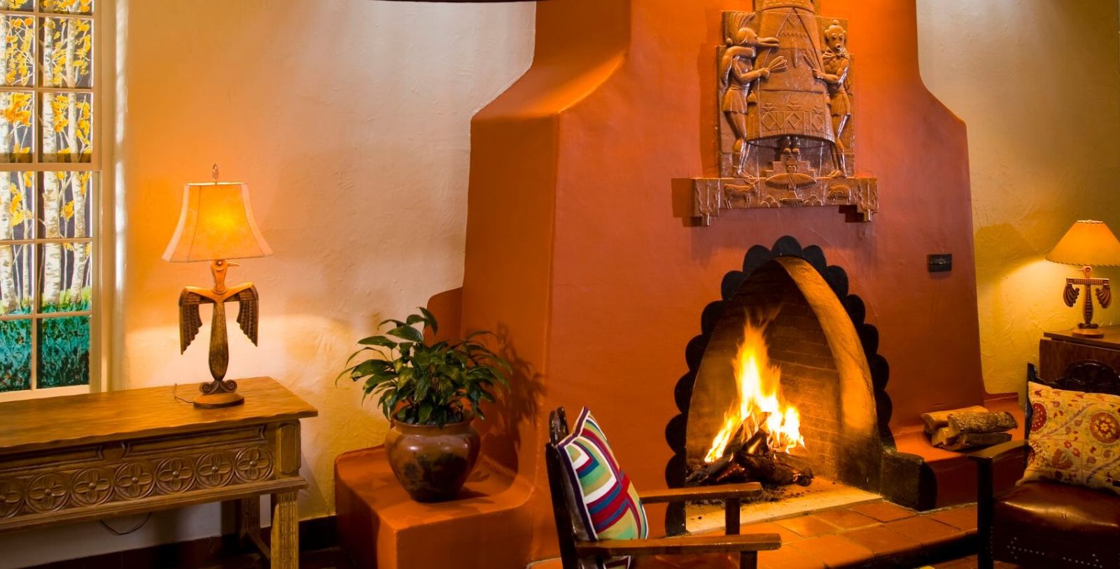 a fireplace with a wood burning in the corner of a room