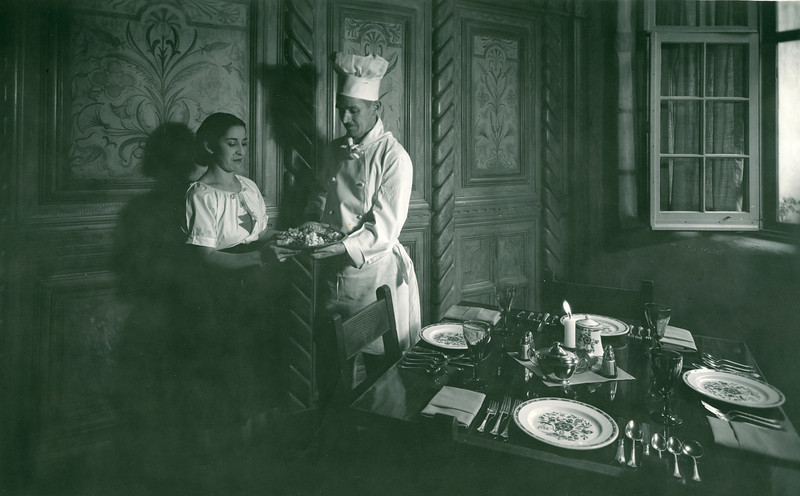 a chef serving food to a woman