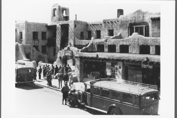 a group of people outside a hotel