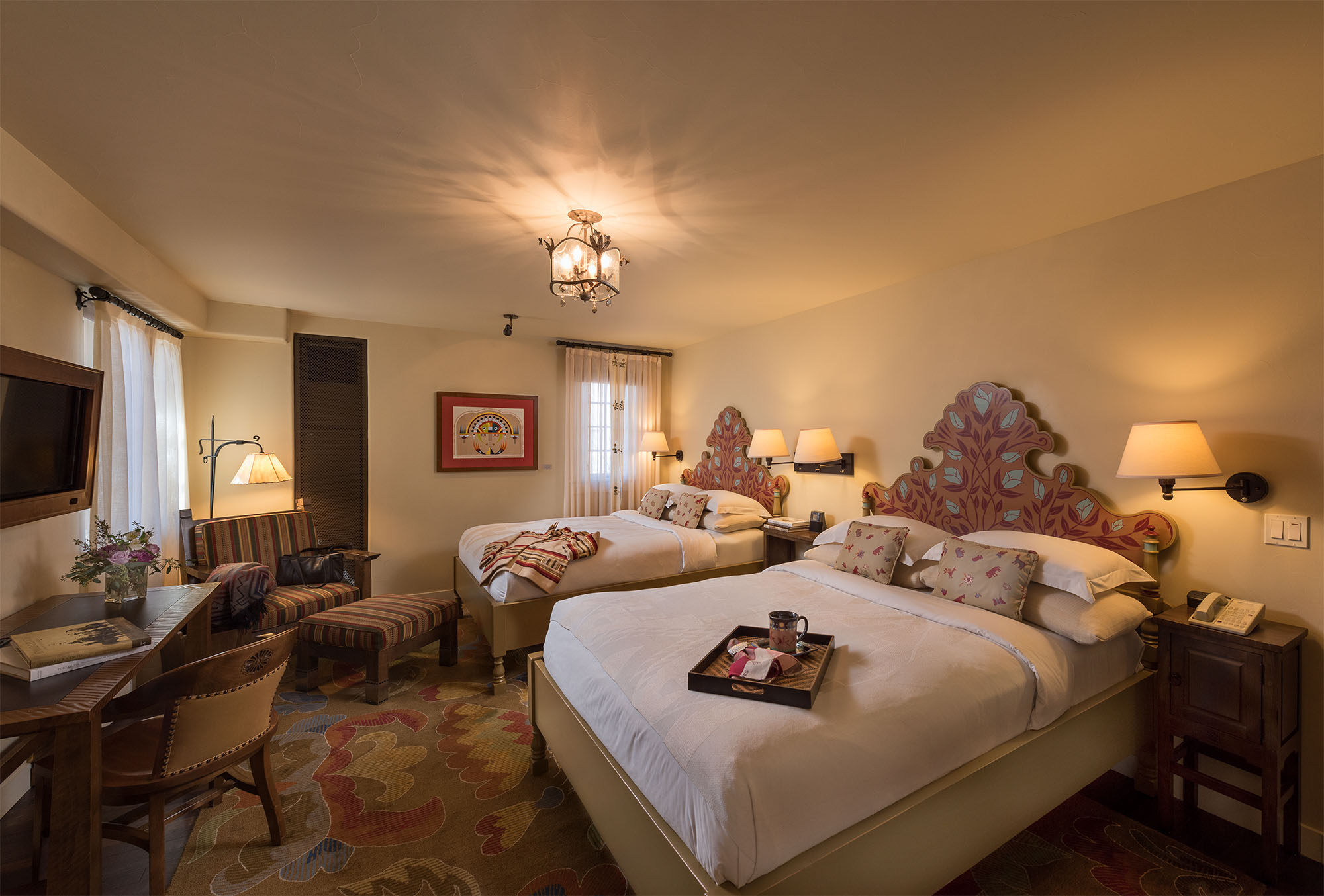 a room with two beds and a chair
