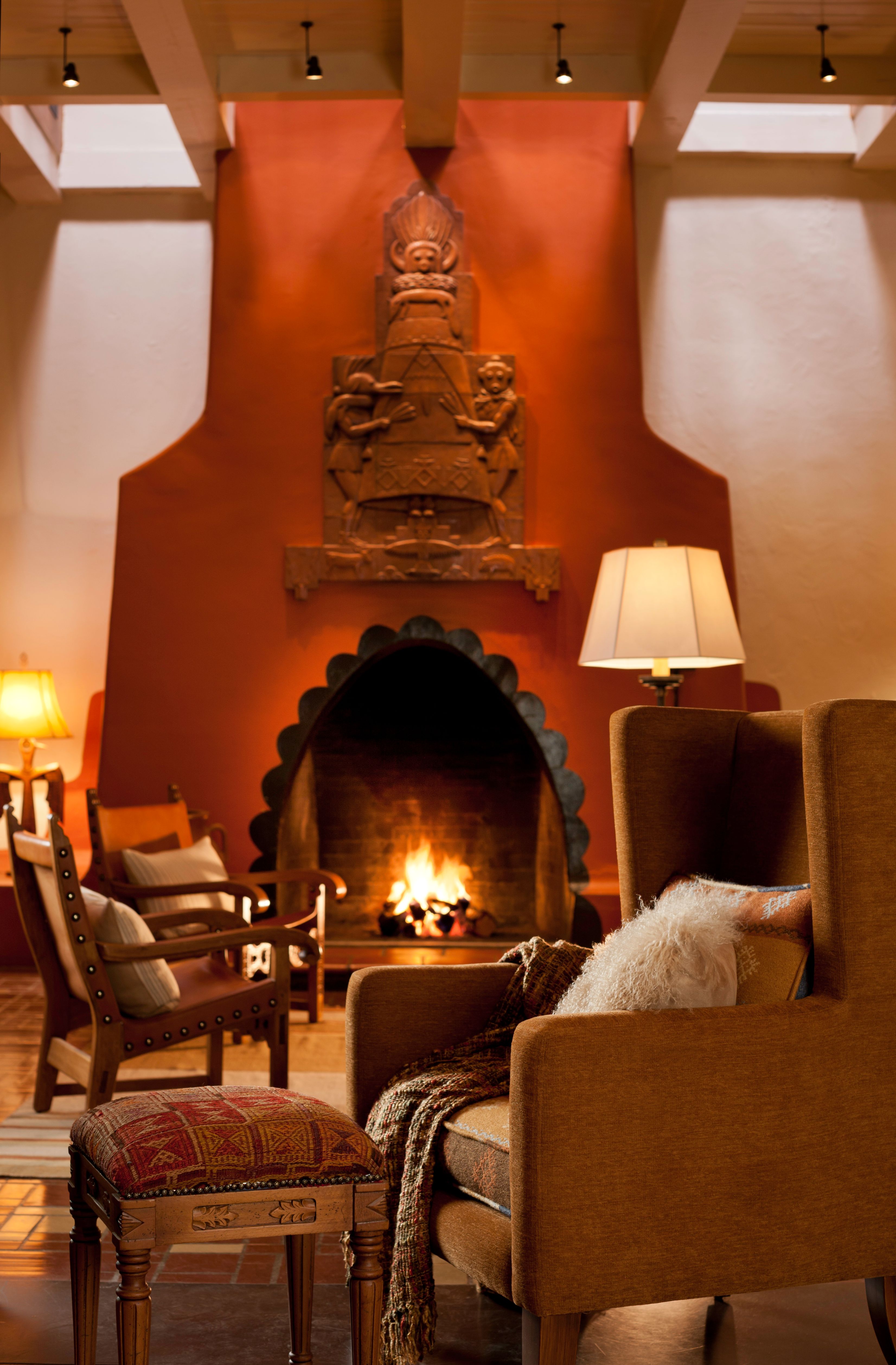 a fireplace with a couch and chairs