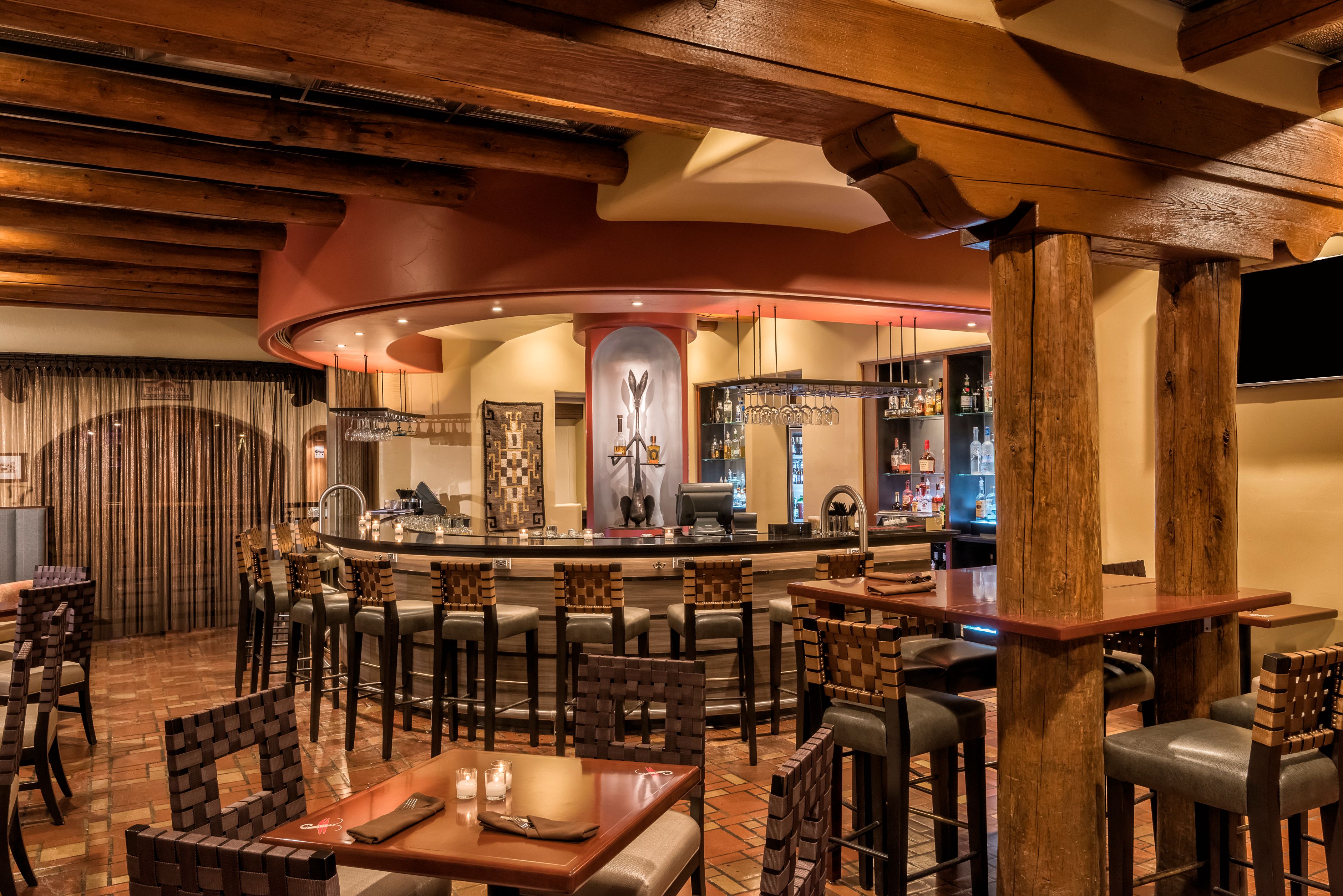 a bar with a bar and chairs