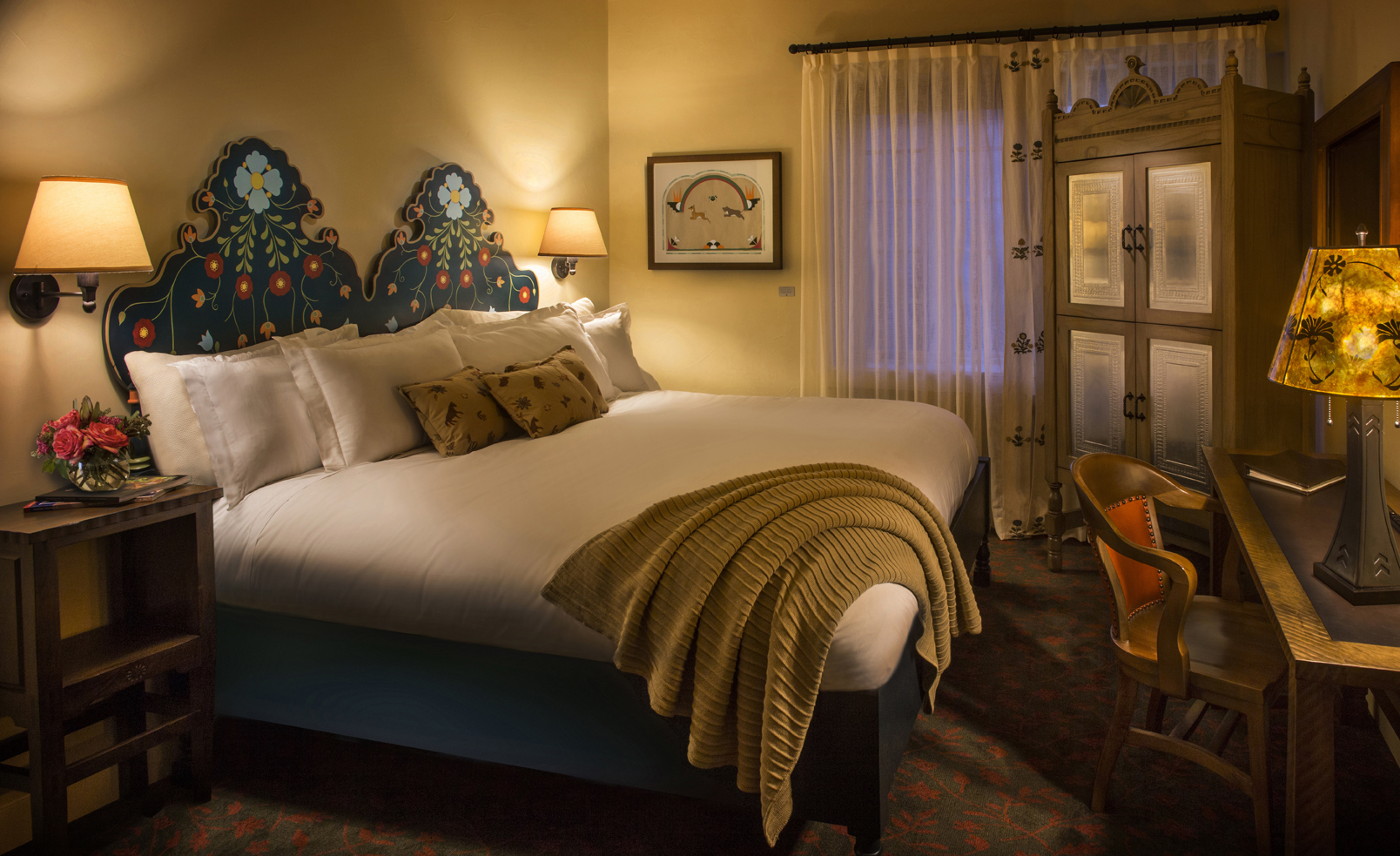 a bed with pillows and a chair in a room