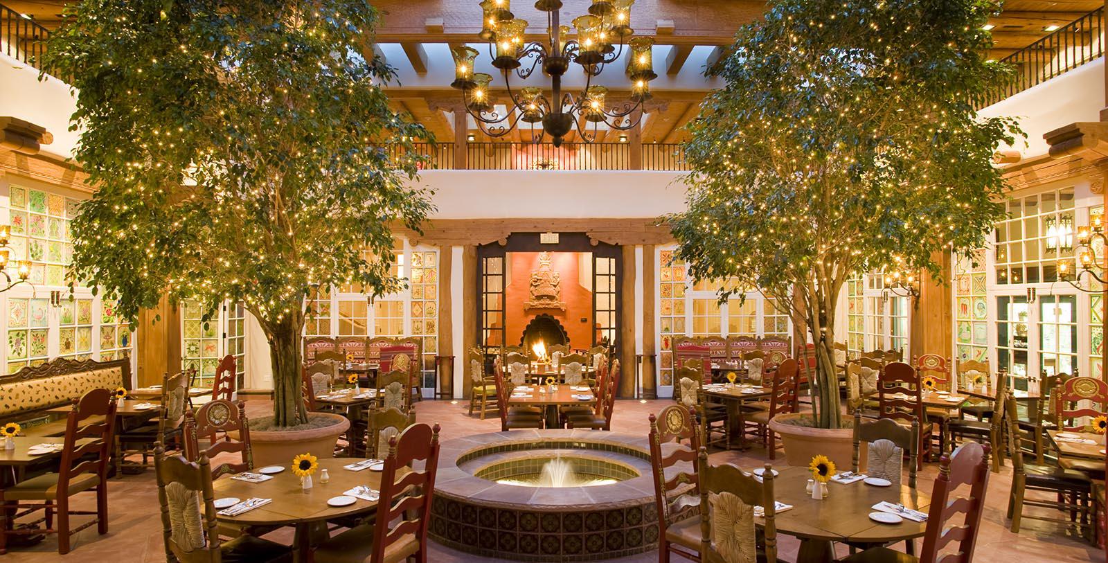 a room with tables and chairs and a fountain