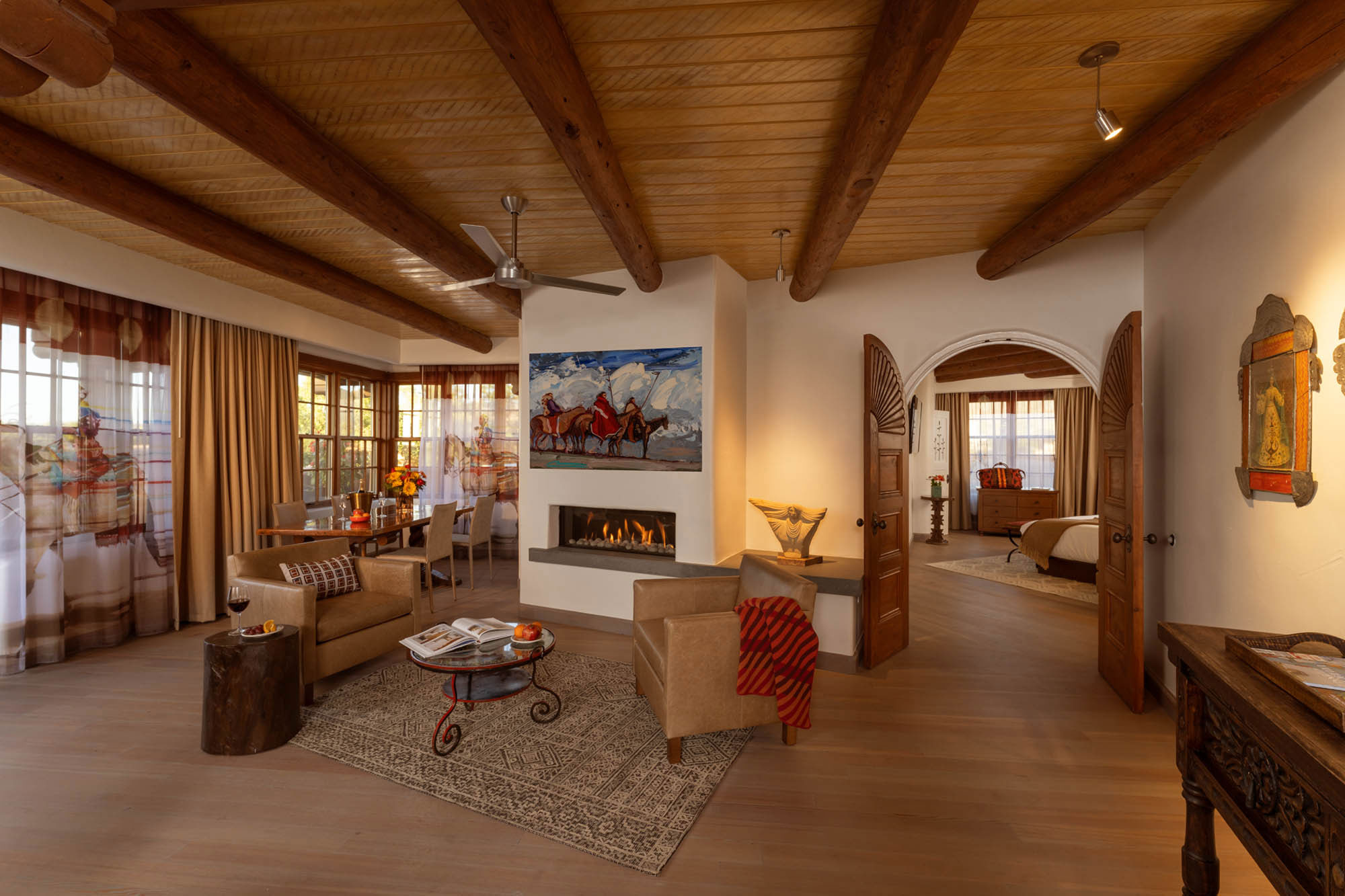 a living room with a fireplace and a bed and a bedroom