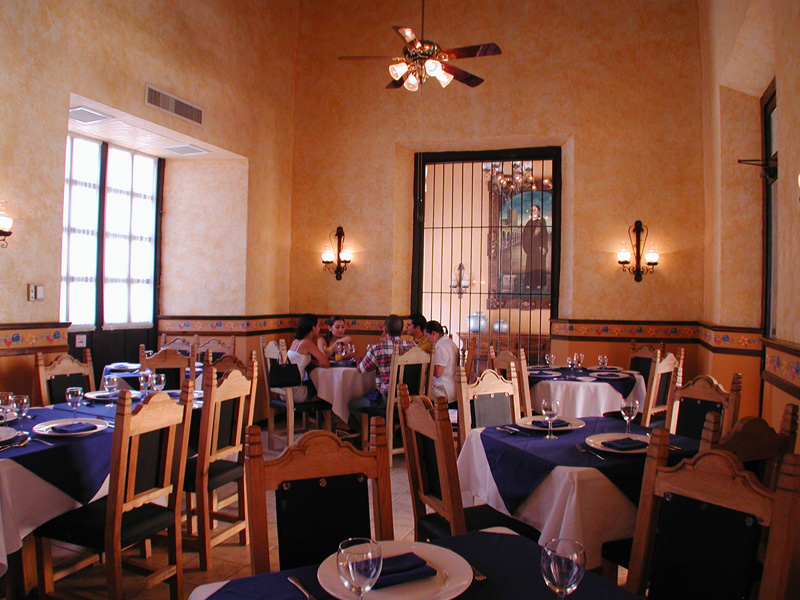 a group of people sitting at tables in a restaurant