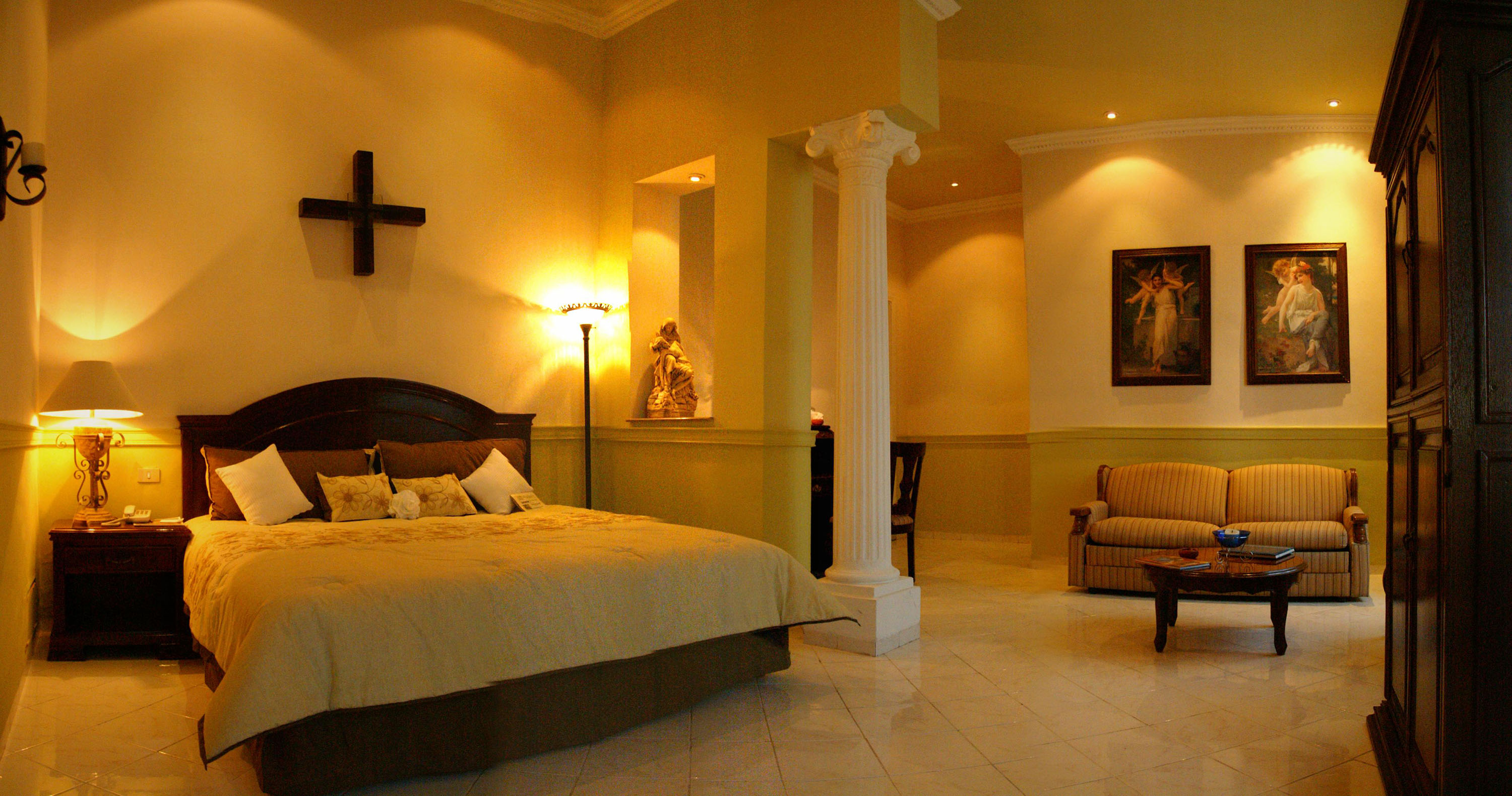 a bedroom with a large bed and a chair