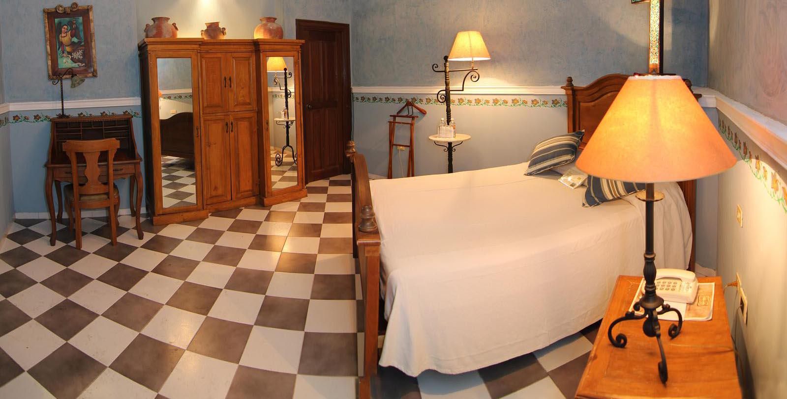 a room with a bed and a checkered floor