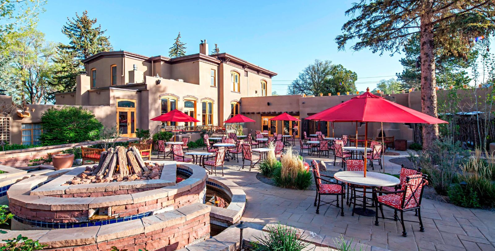 a patio with tables and umbrellas