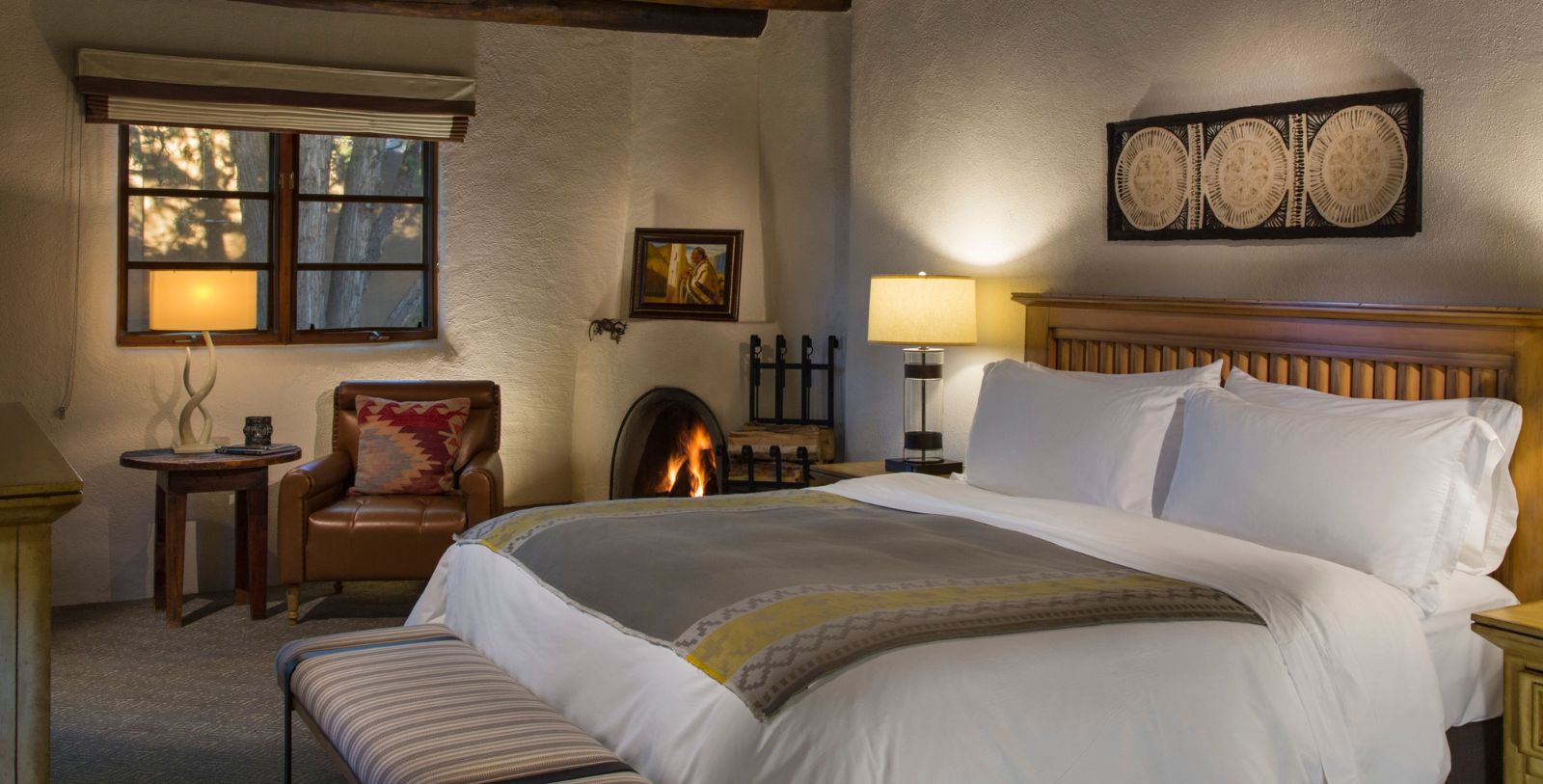 a bed in a room with a fireplace
