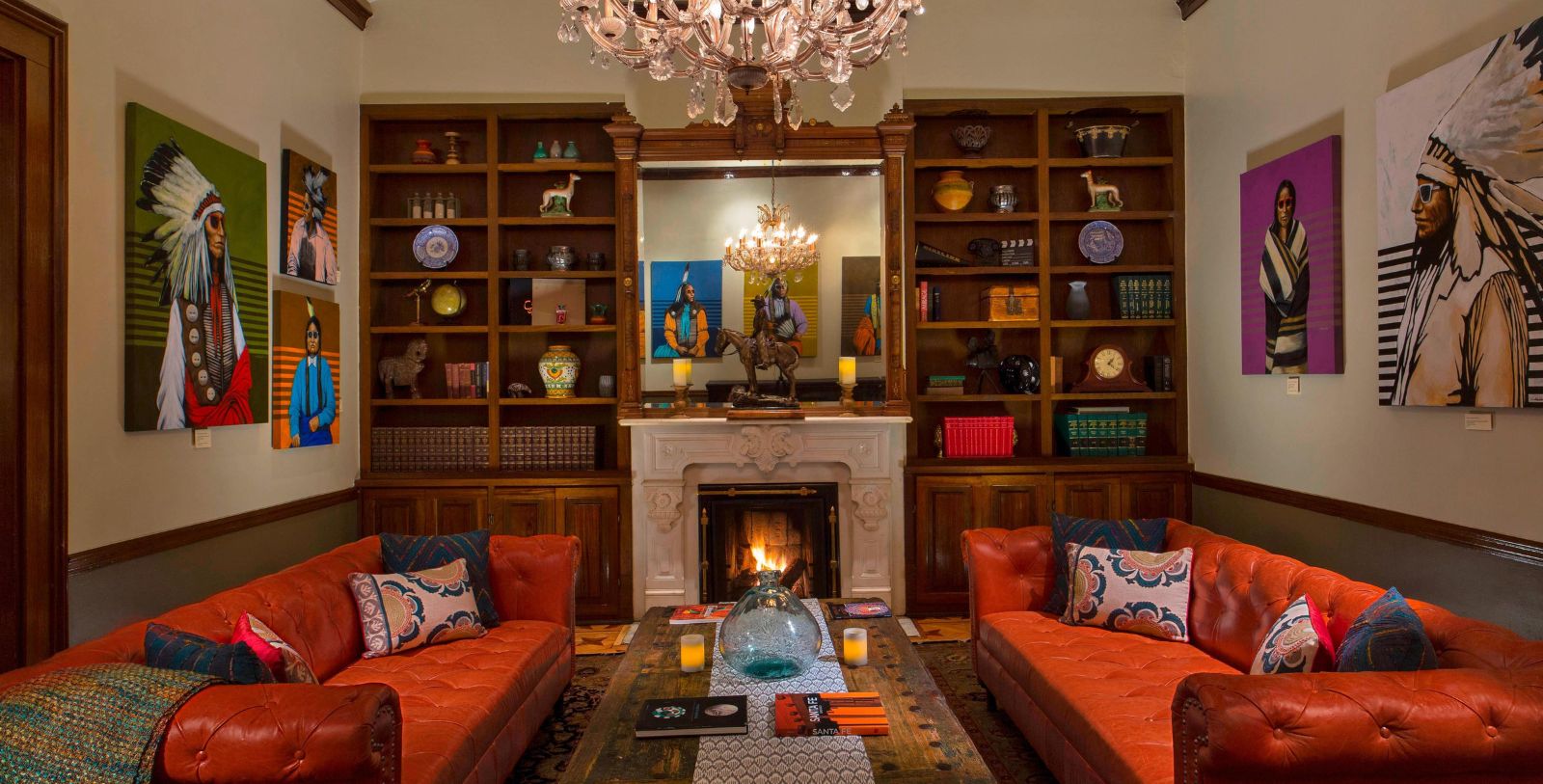 a living room with a fireplace and a chandelier