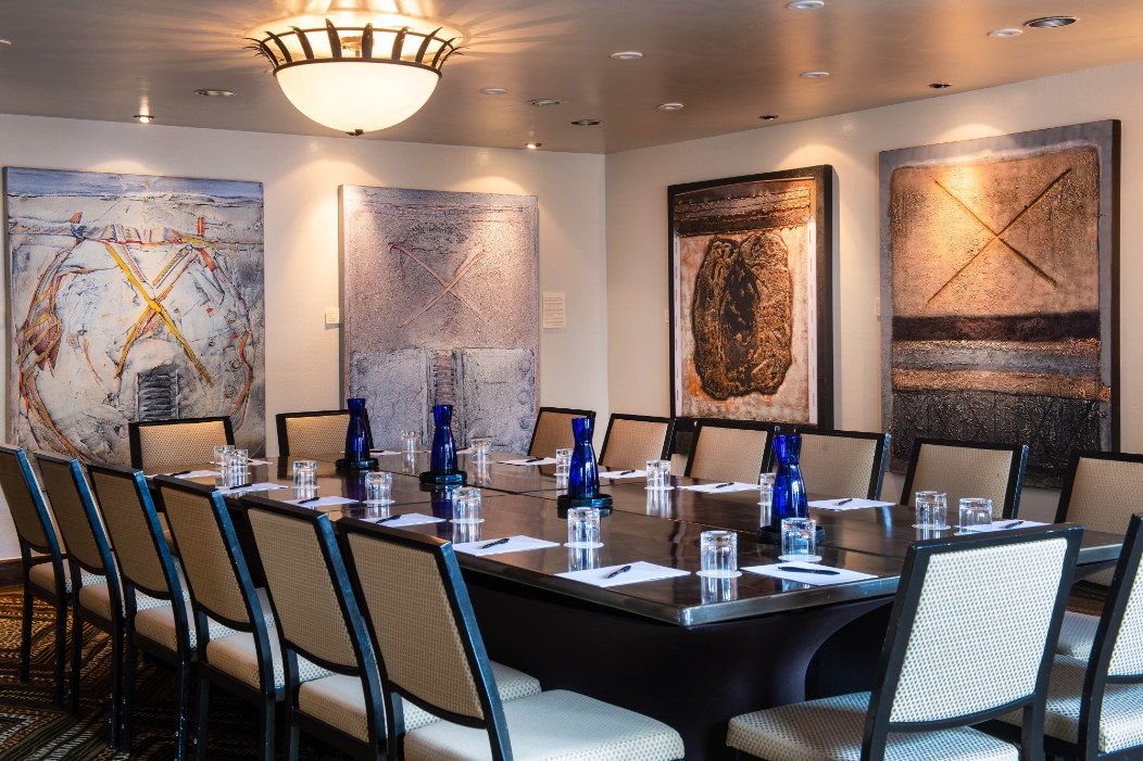 a room with a long table and chairs