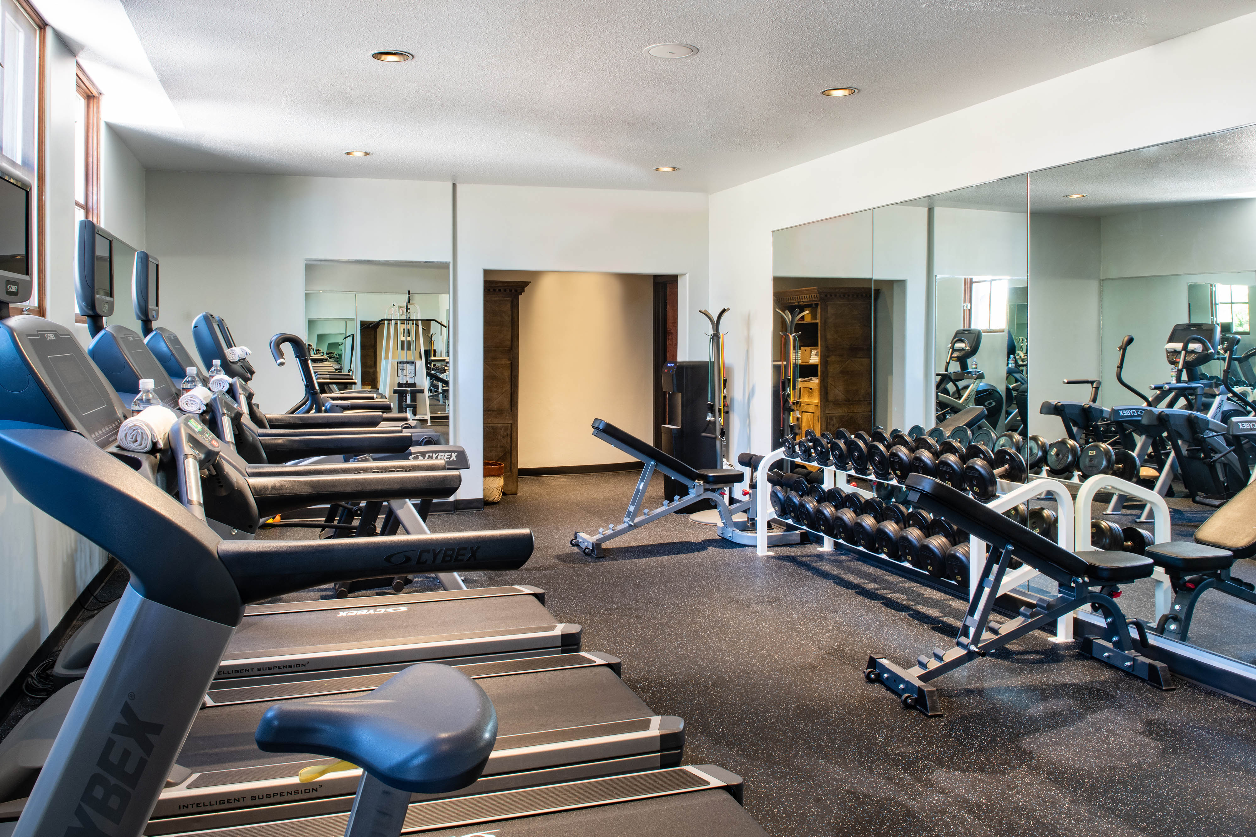 a large room with treadmills and exercise equipment