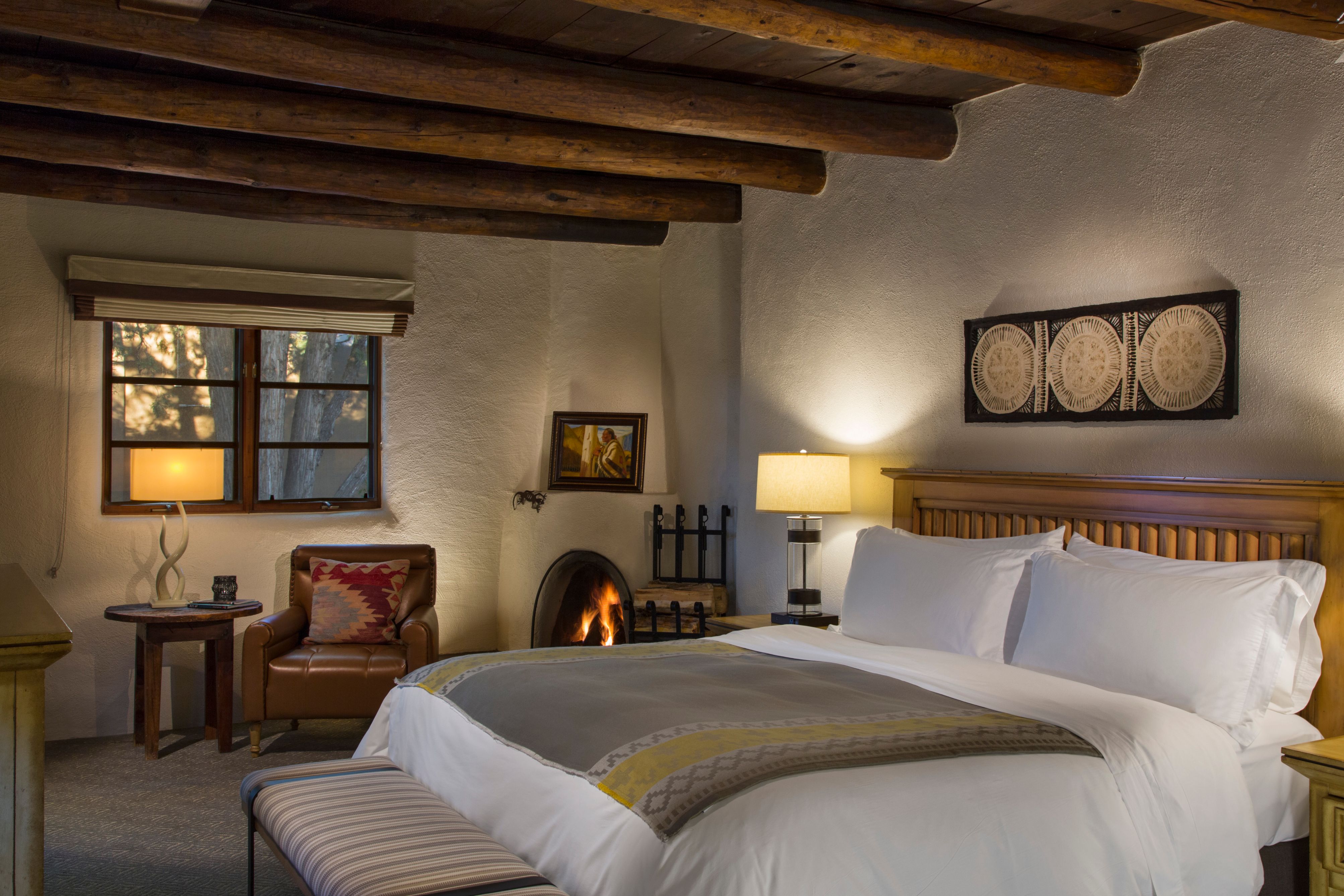 a bed in a room with a fireplace