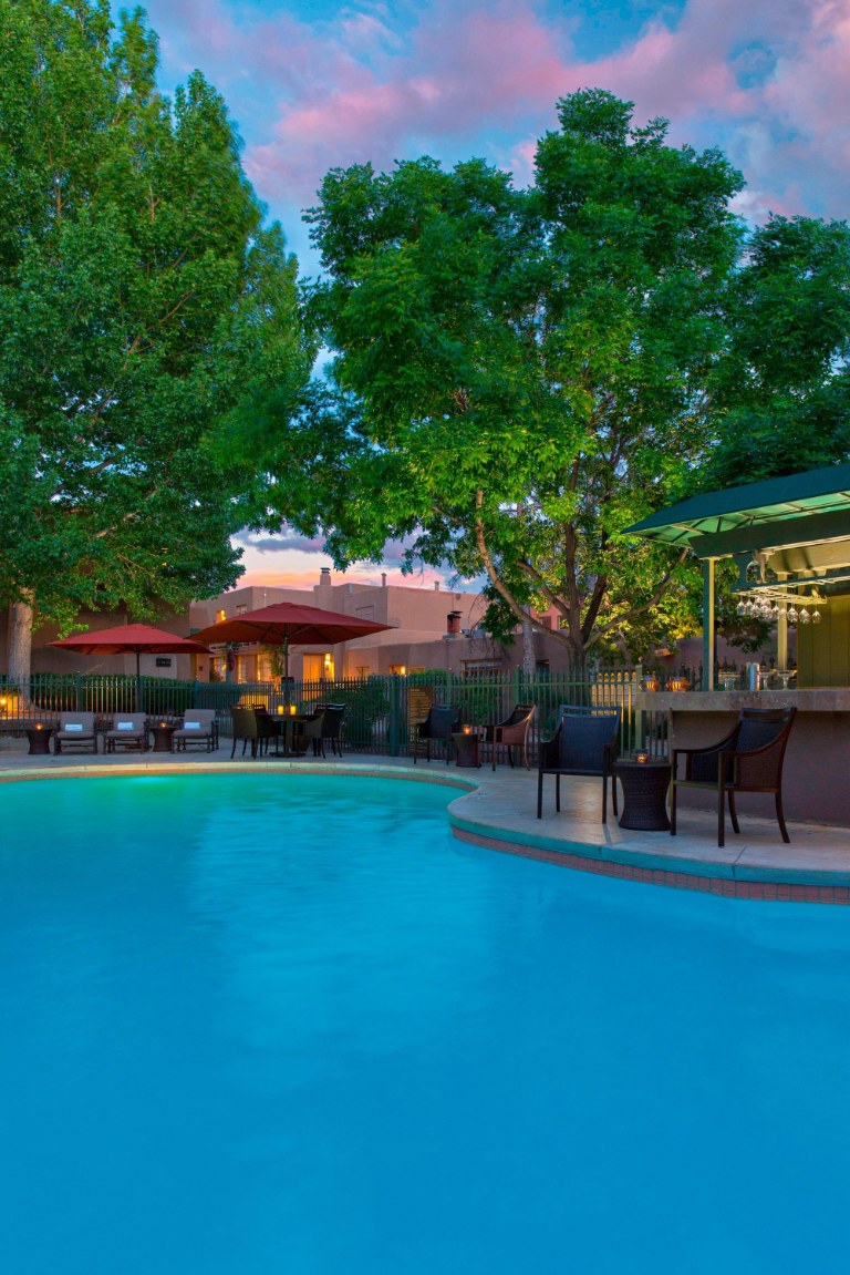 a pool with chairs and umbrellas