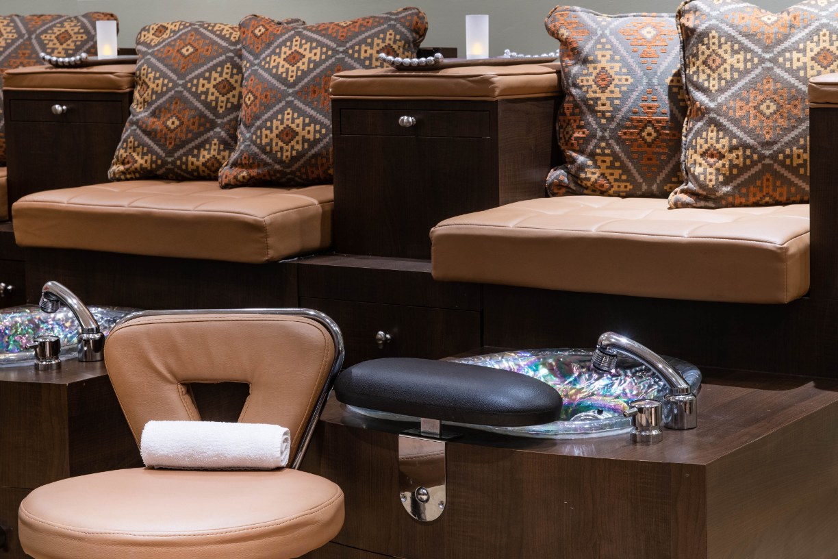 a pedicure sink and chairs in a room