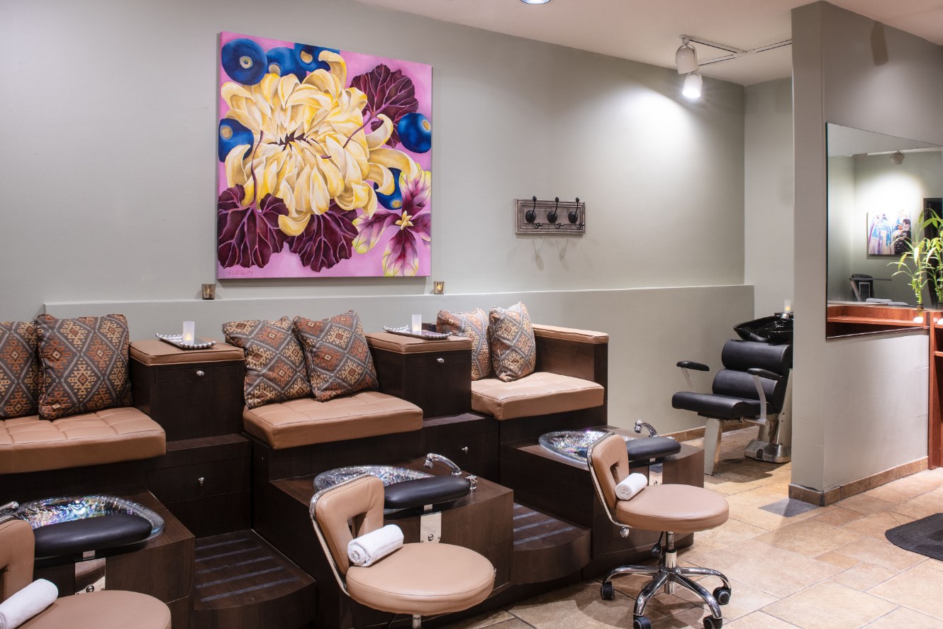 a room with chairs and a painting on the wall