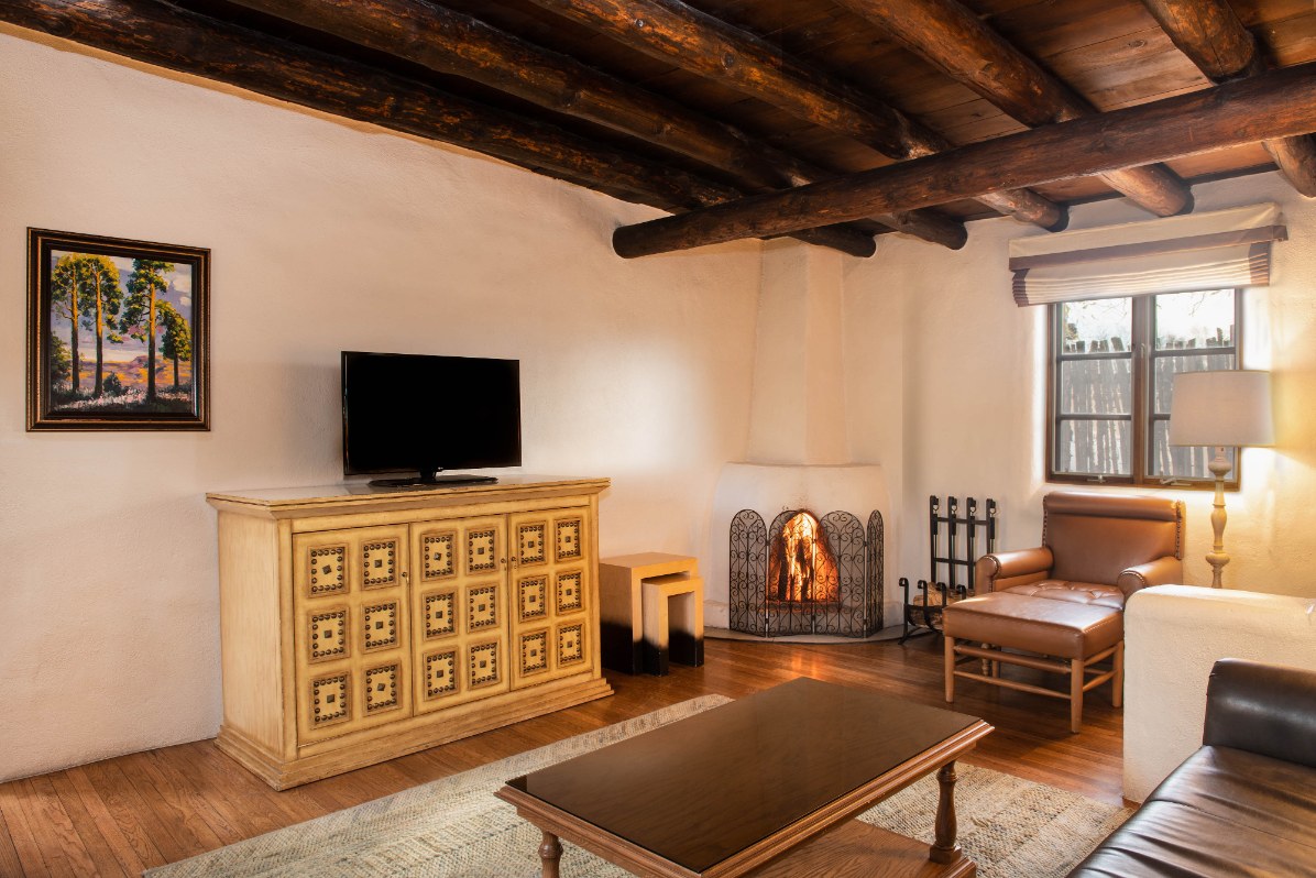 a living room with a fireplace and a tv