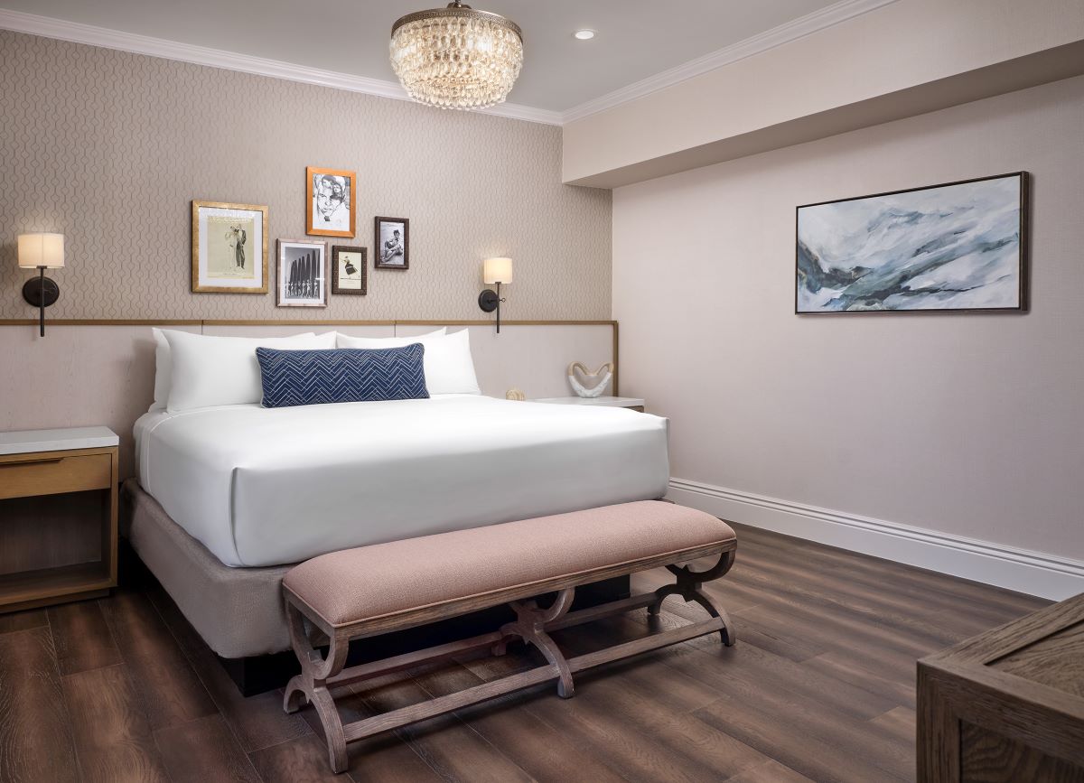 a bedroom with a bed and a bench