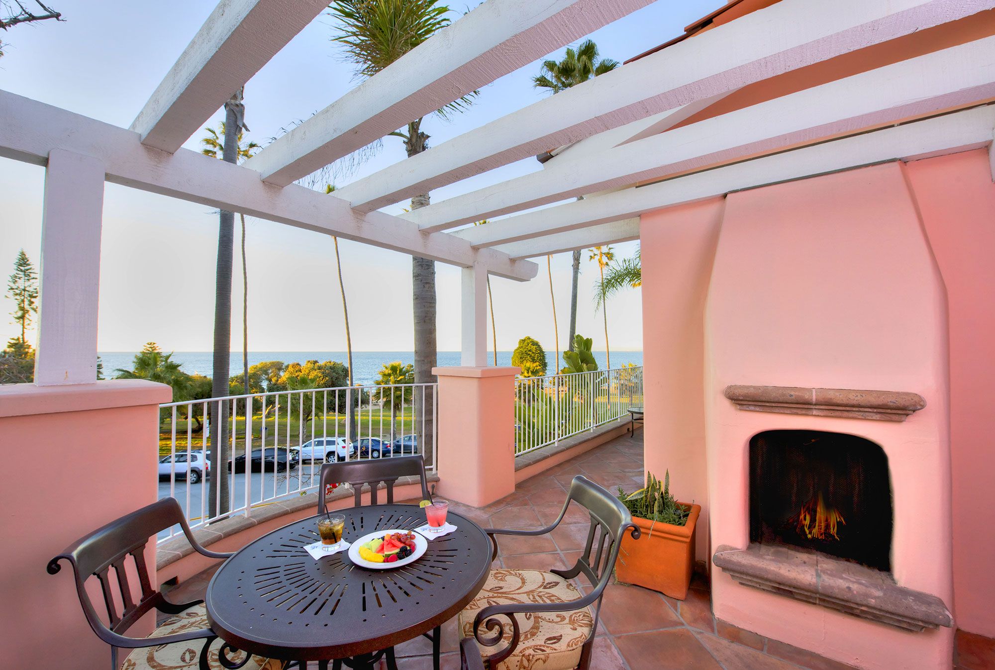 a patio with a table and chairs and a fireplace