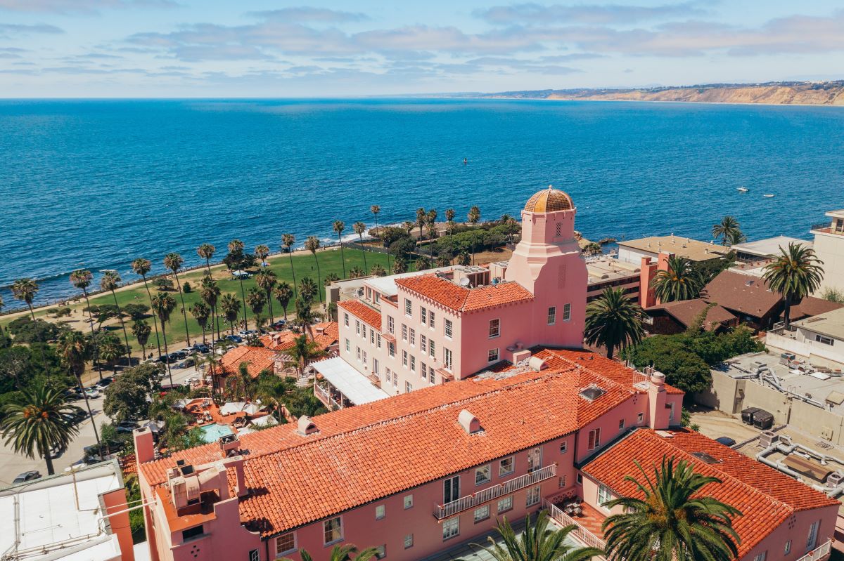 a large building with a large tower and a body of water