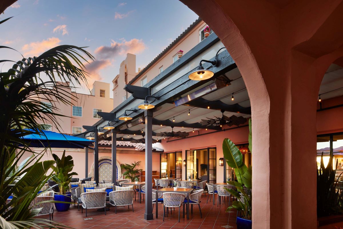 a patio with tables and chairs