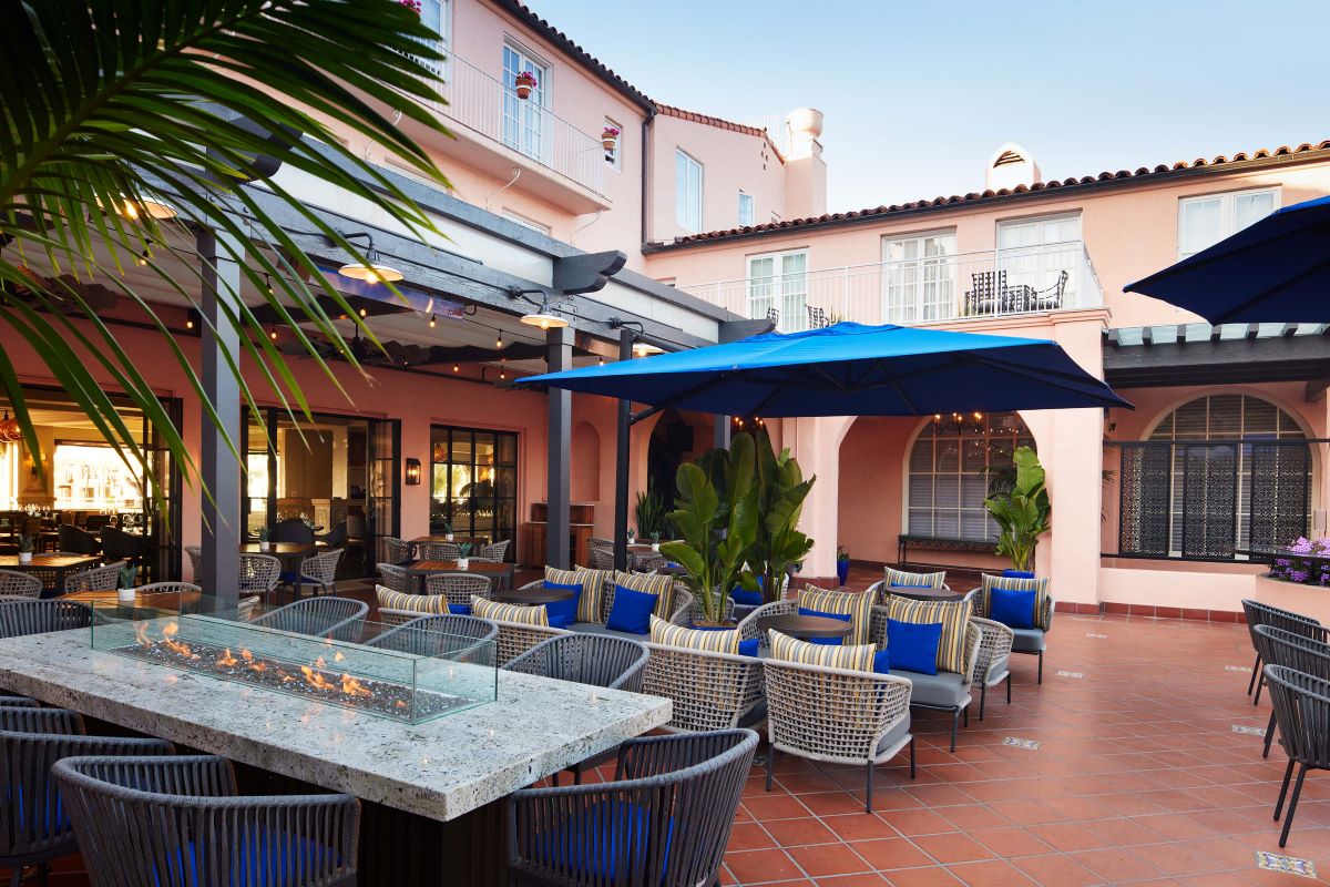 a patio with chairs and a fire pit