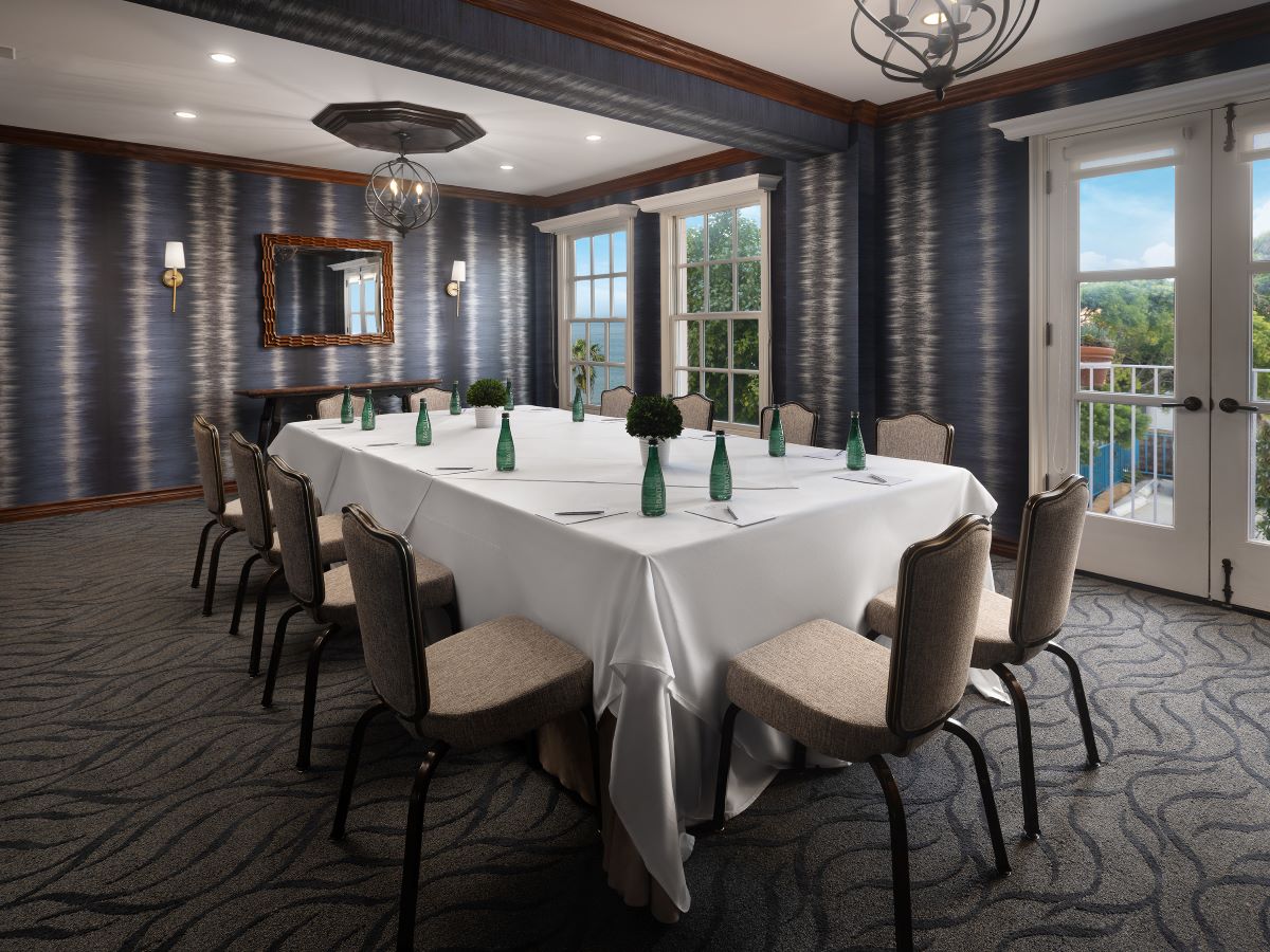 a room with a long table and chairs