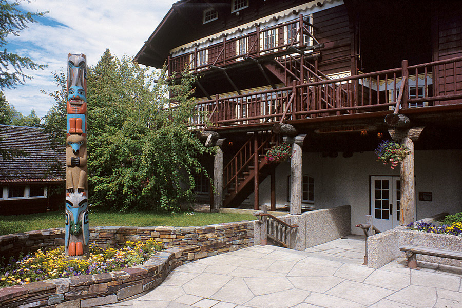 image of exterior front entrance with totem pole lake mcdonald lodge glacier national park montana_high