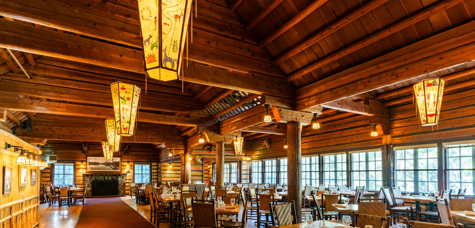 a room with wooden beams and tables and chairs