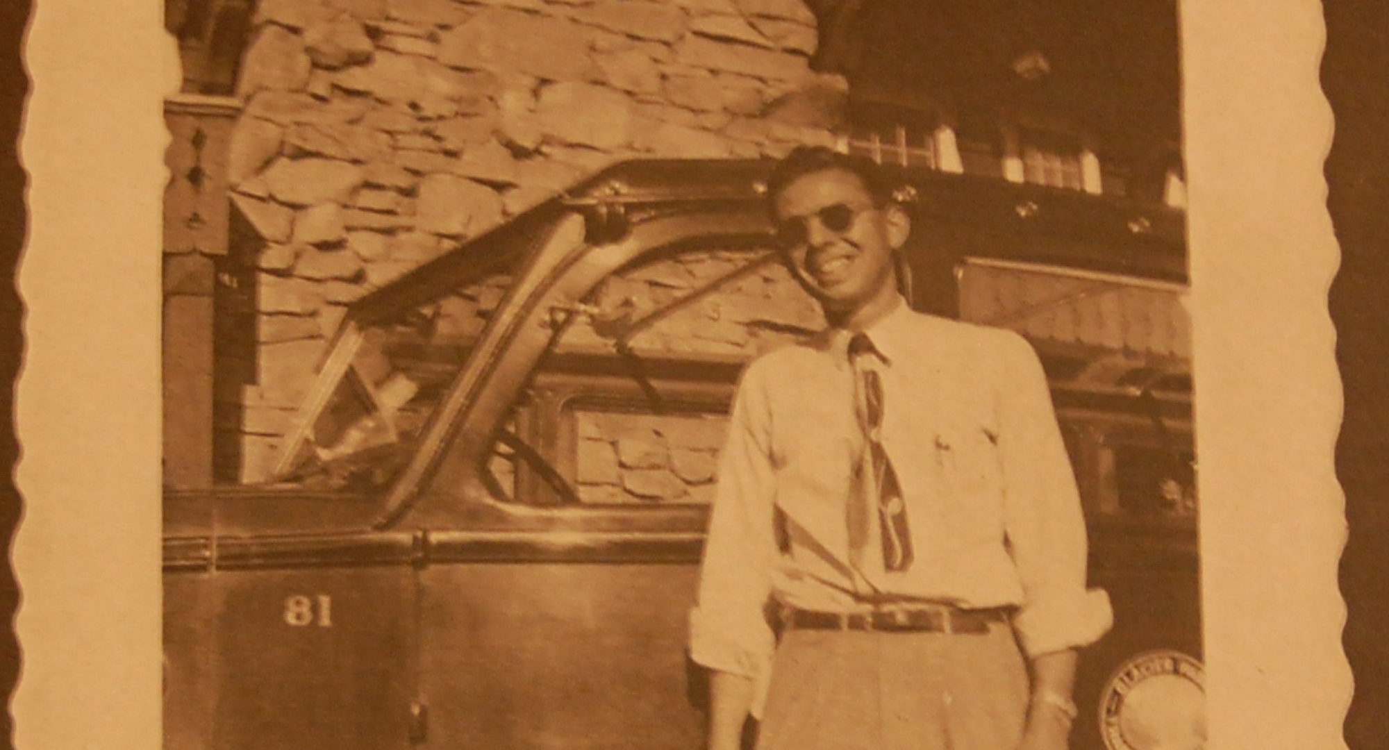 a man standing in front of a car