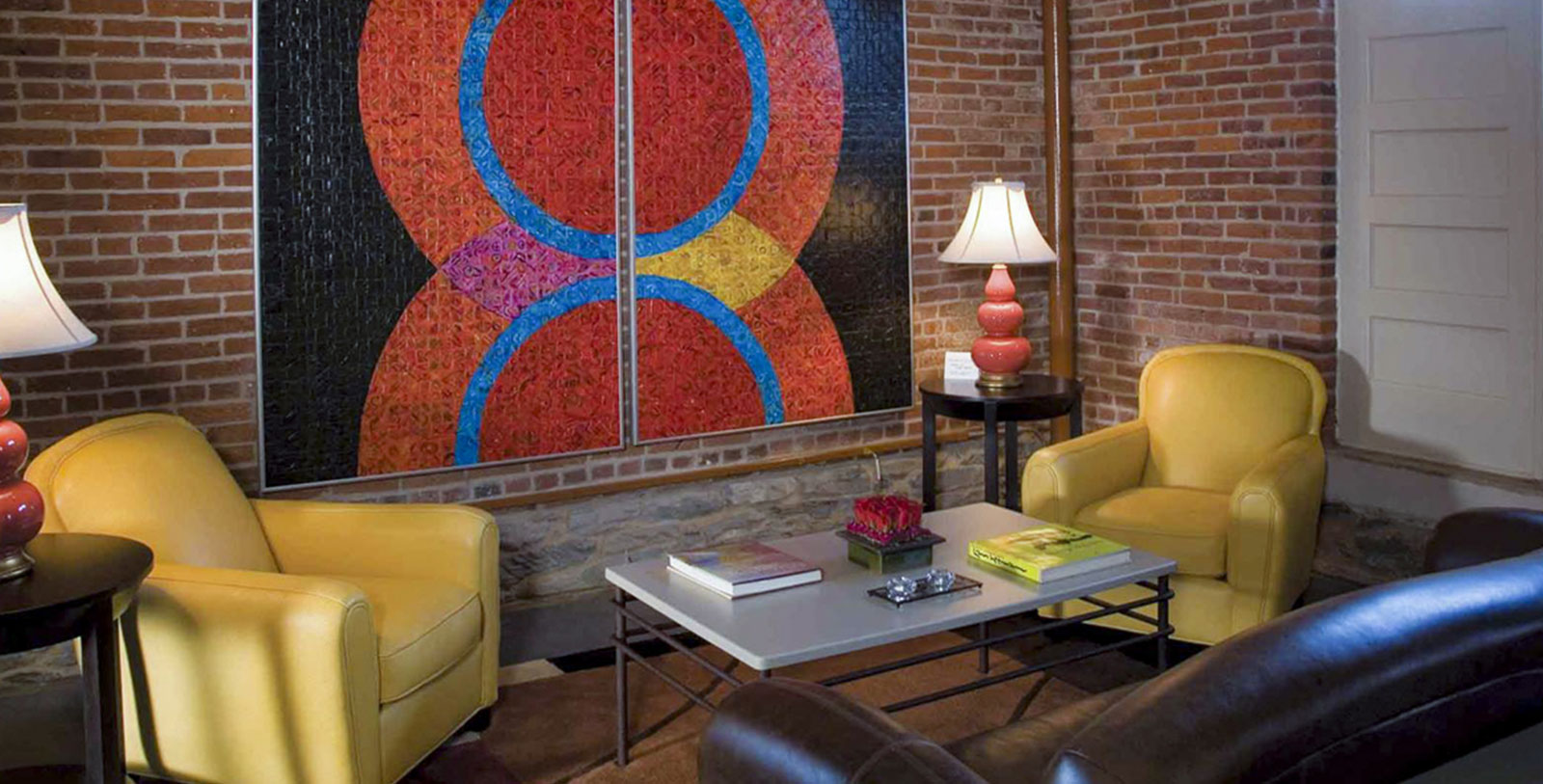 a room with a large art piece on the wall