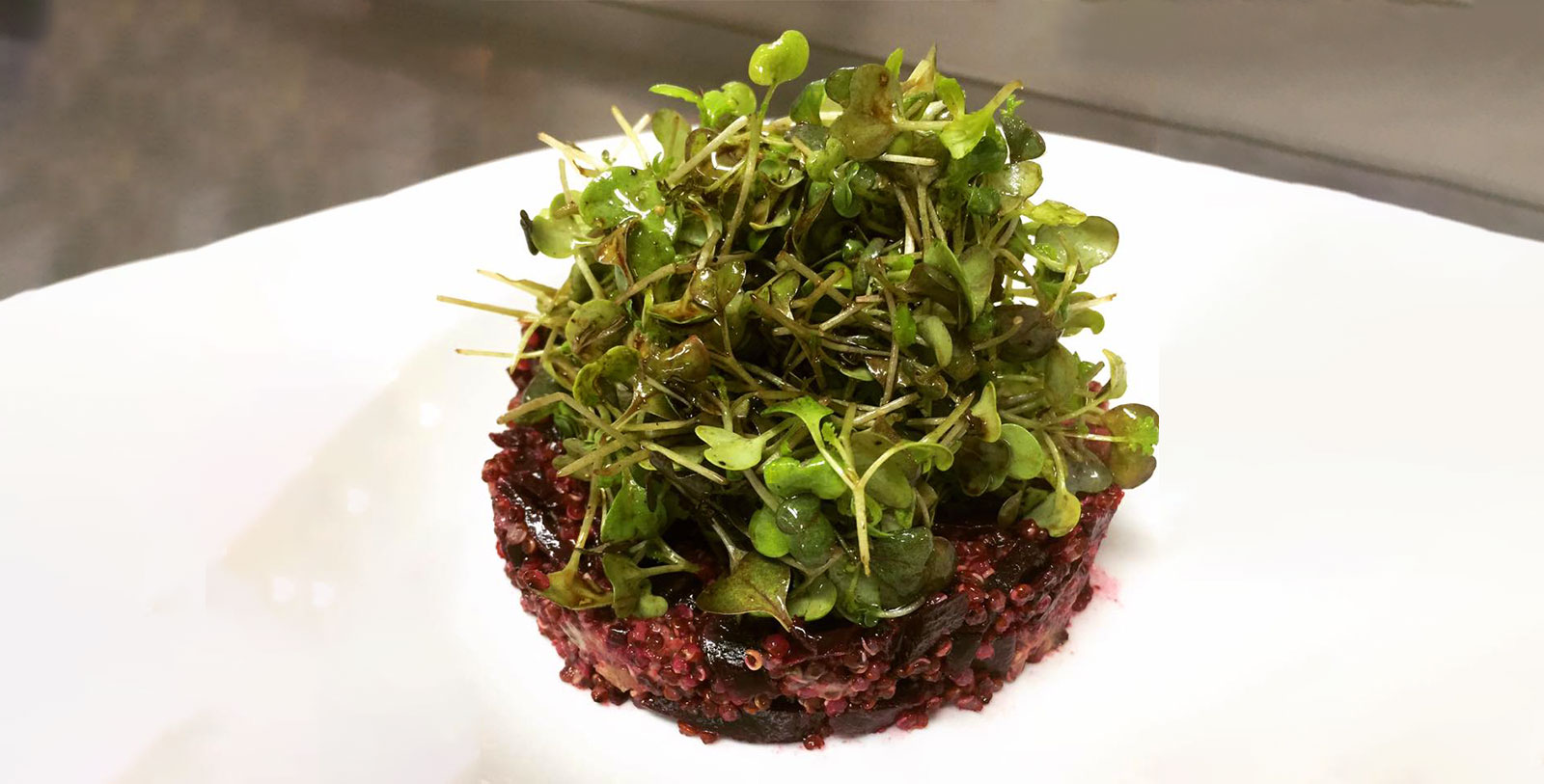 a plate of food with green sprouts