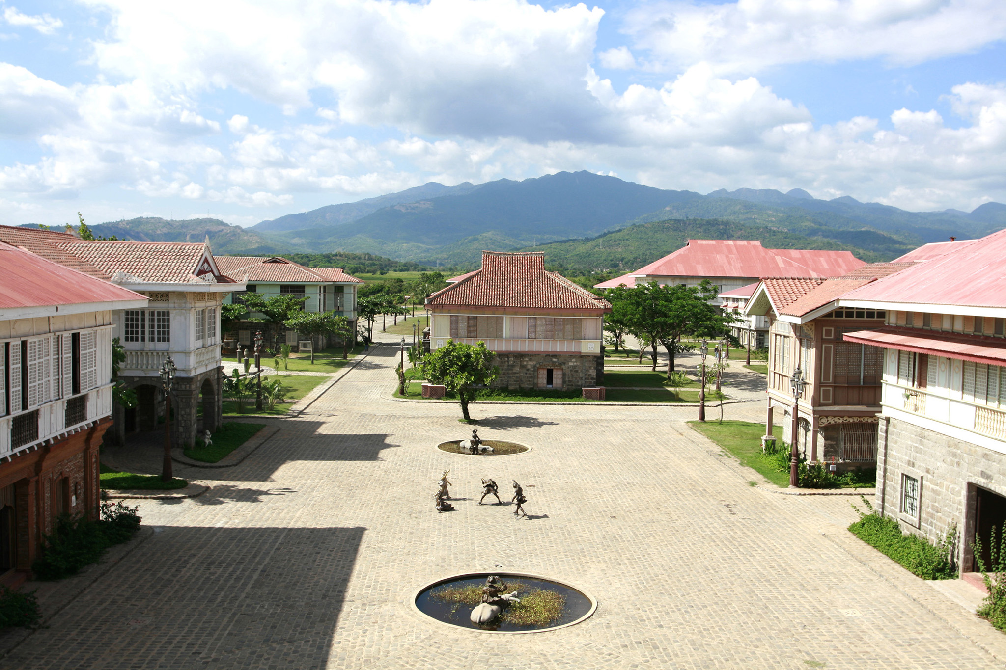 a courtyard with a fountain in the middle of a town