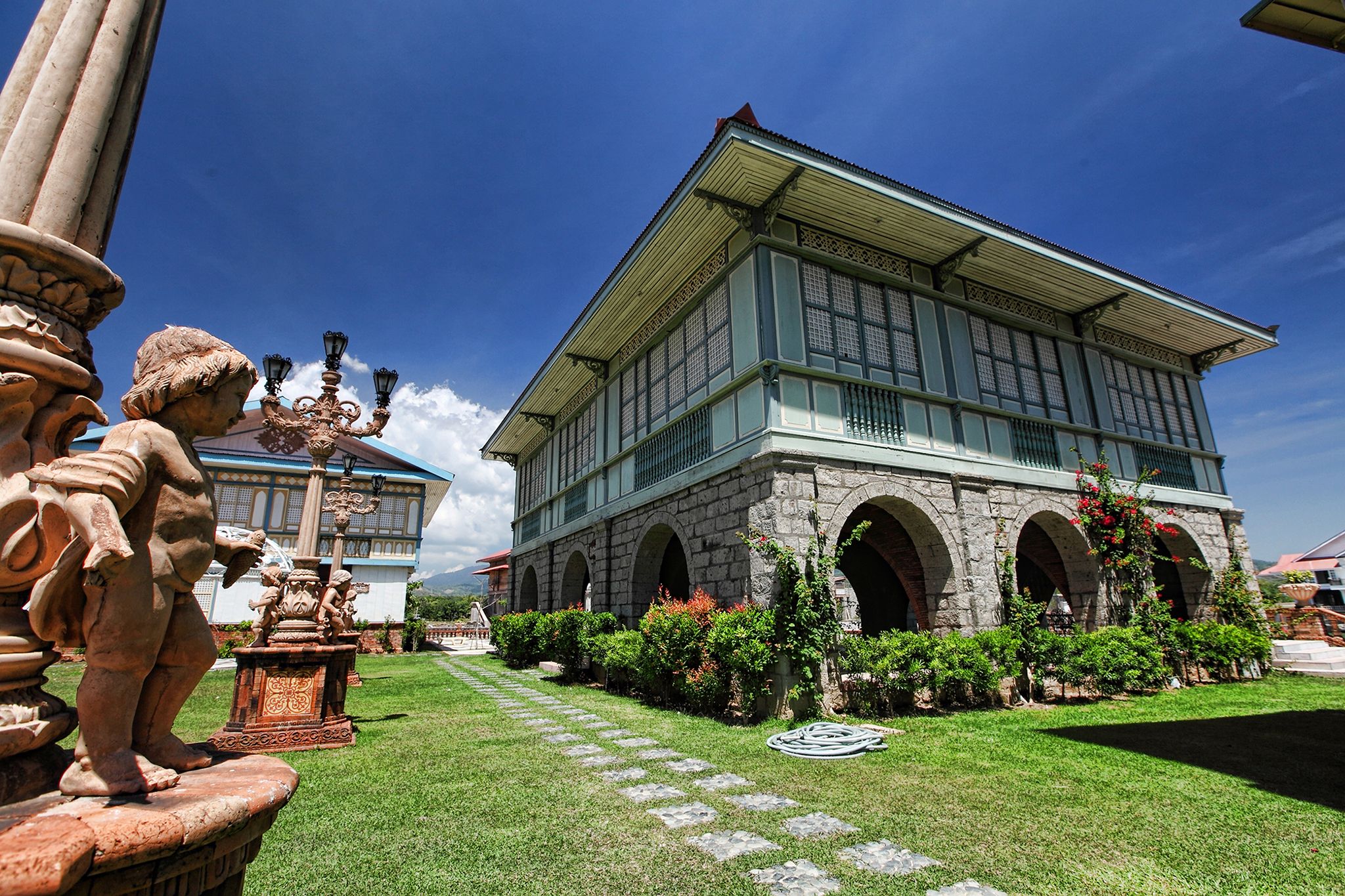 a building with a stone walkway and a fountain