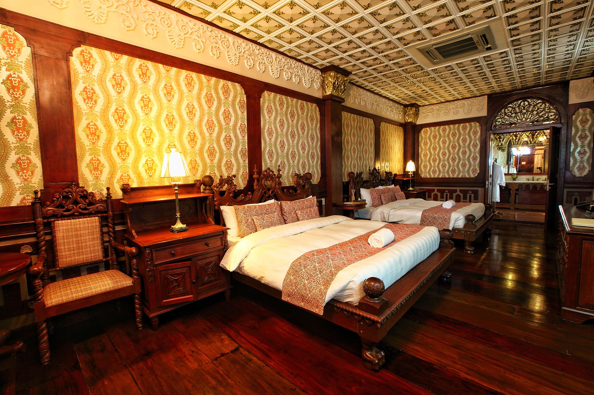 a room with two beds and a wood floor