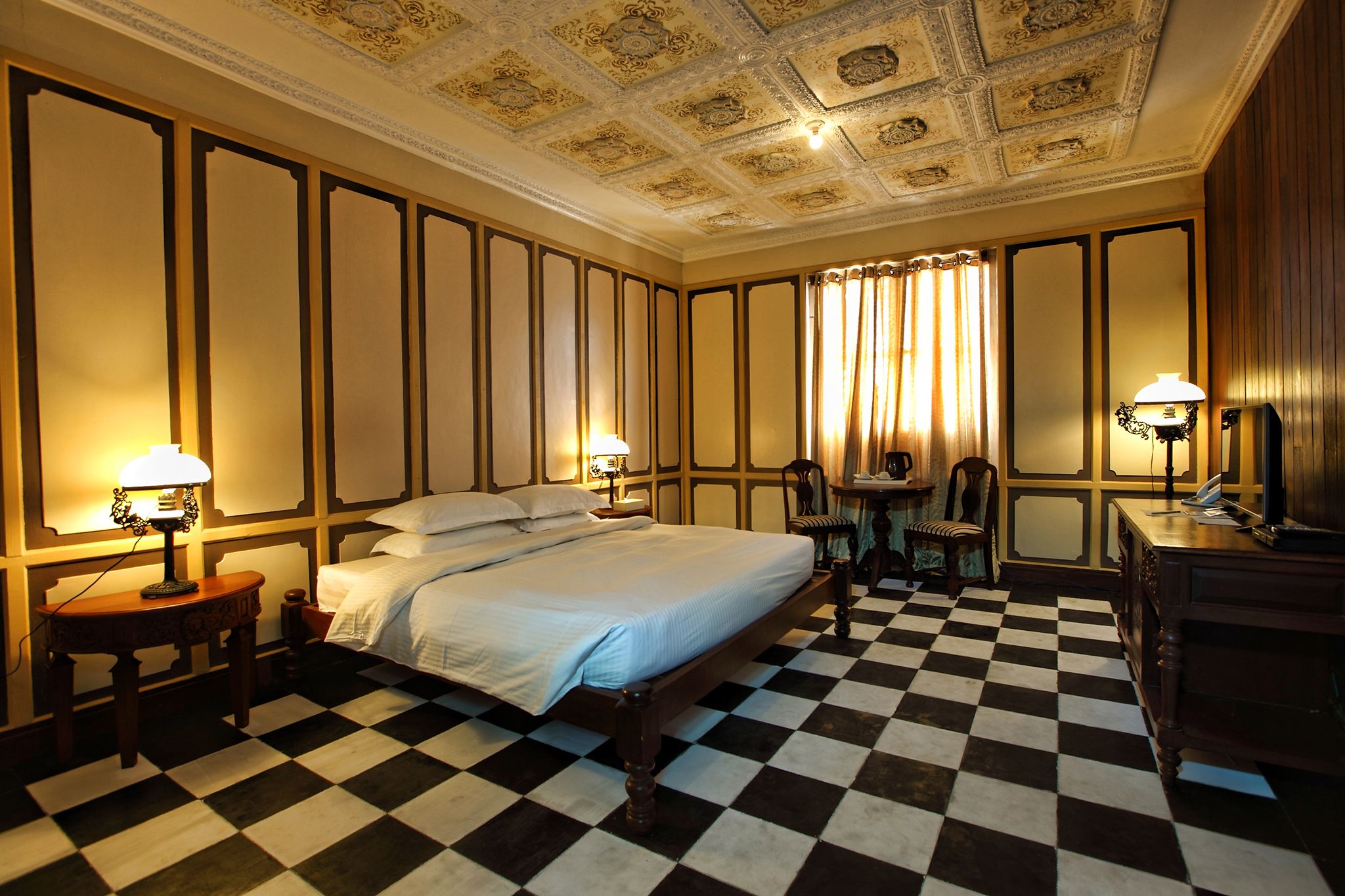 a room with a bed and a checkered floor