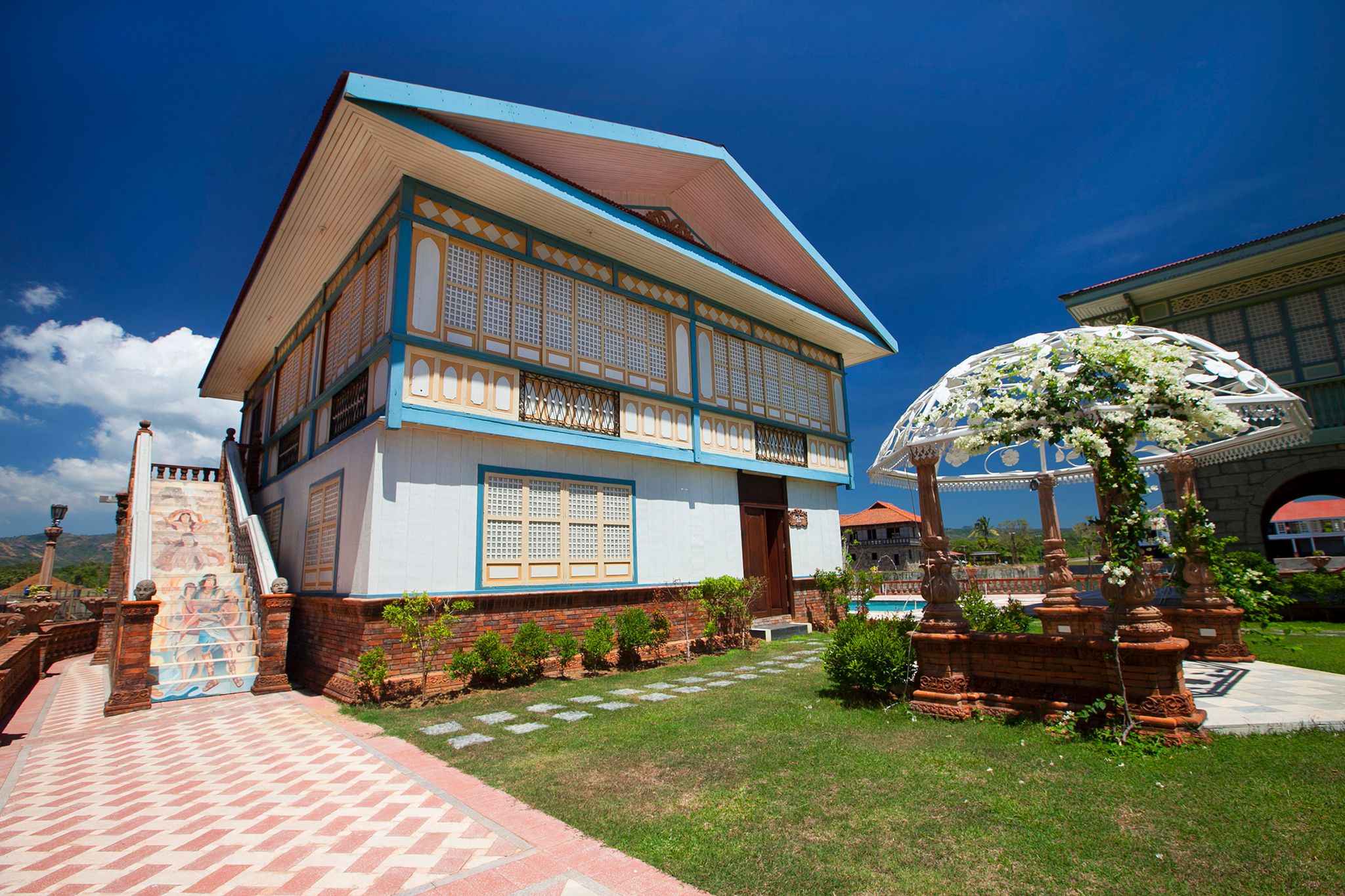 a building with a lawn and a pergola