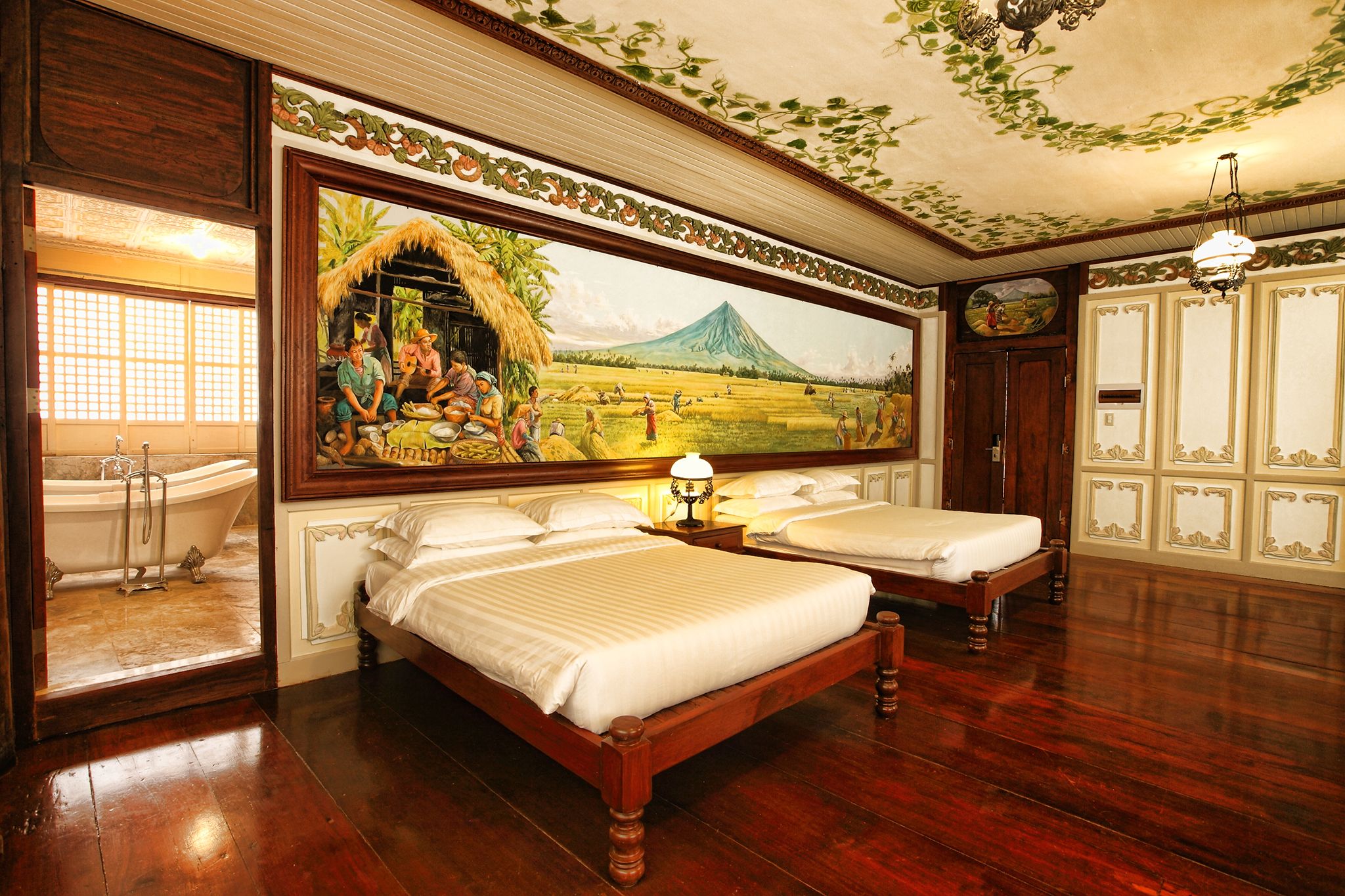 a room with two beds and a painting on the wall