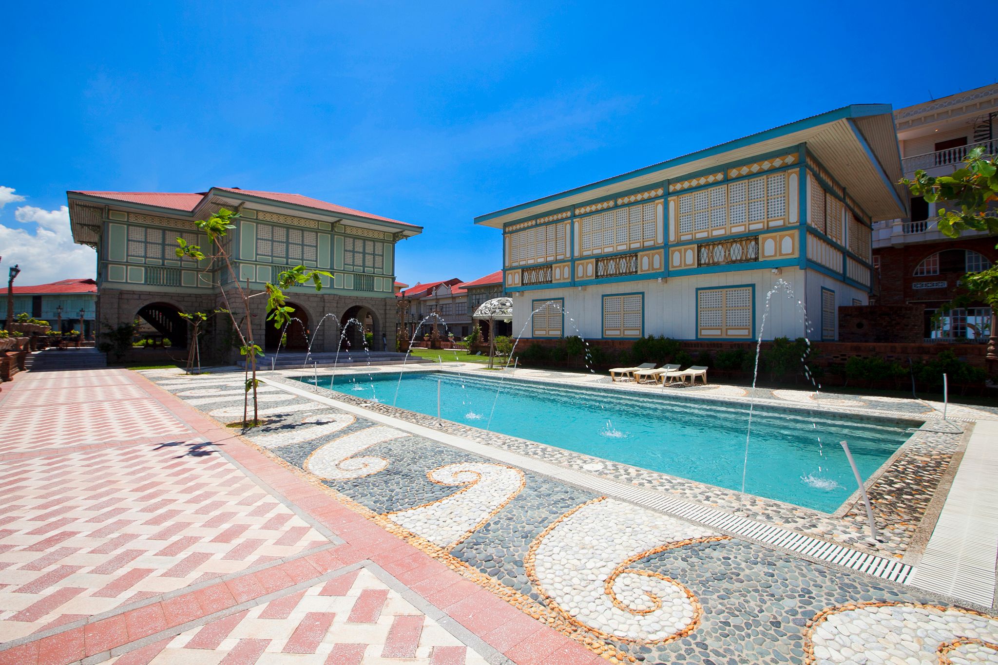 a pool with water in it and a building with a pool in the background