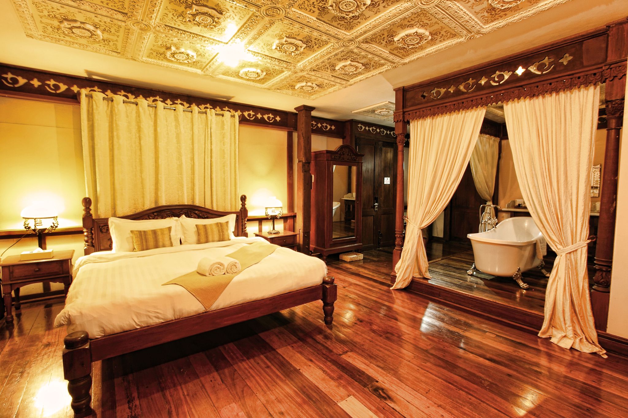 a bedroom with a bathtub and a bed