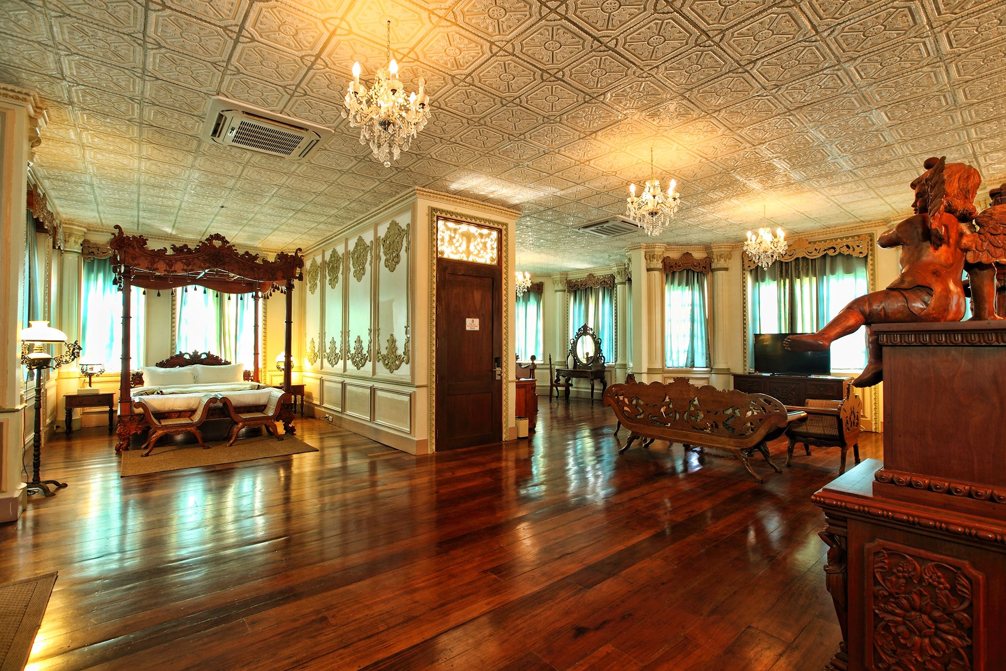 a room with a wood floor and chandelier
