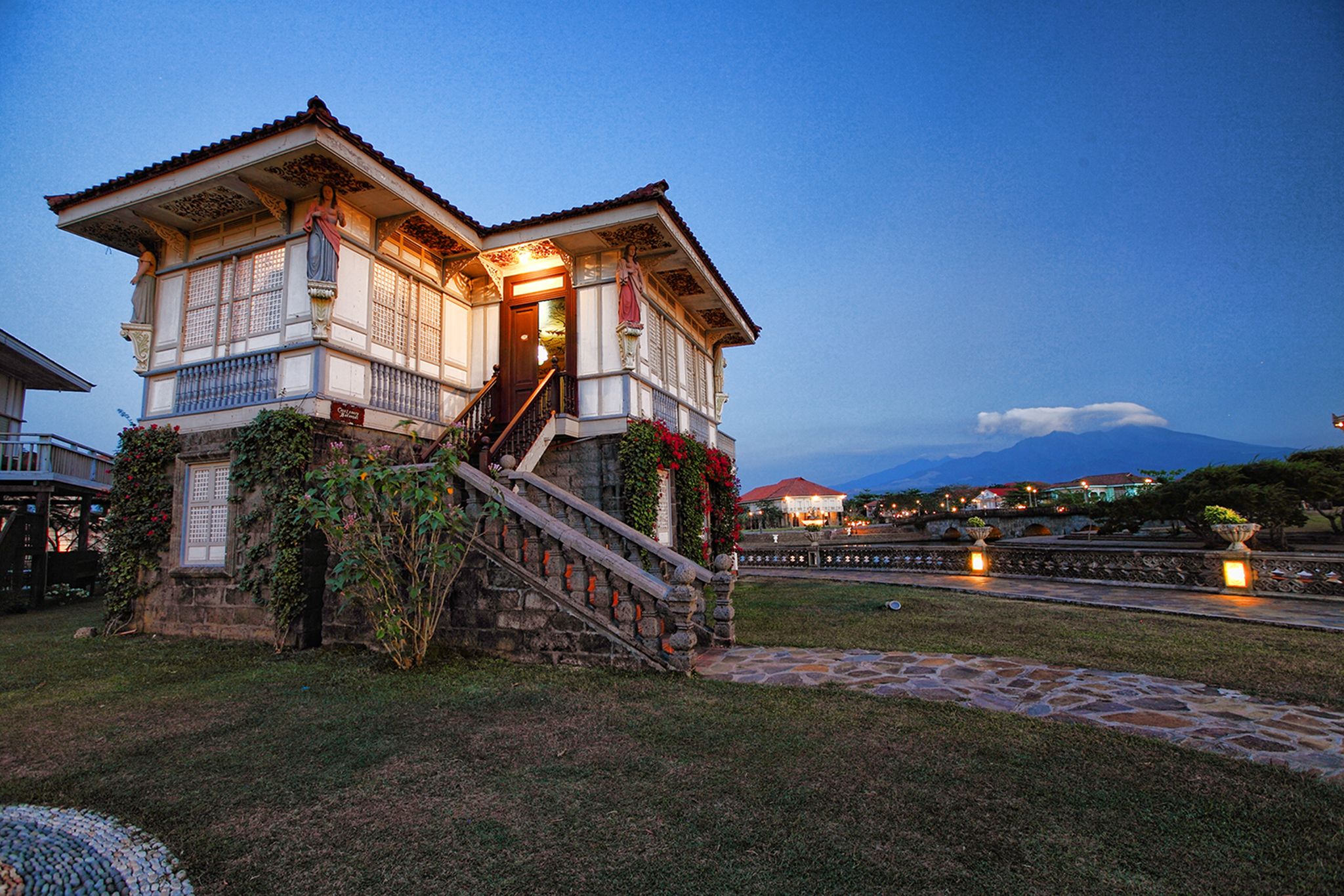 a house with a stone wall and a stone walkway