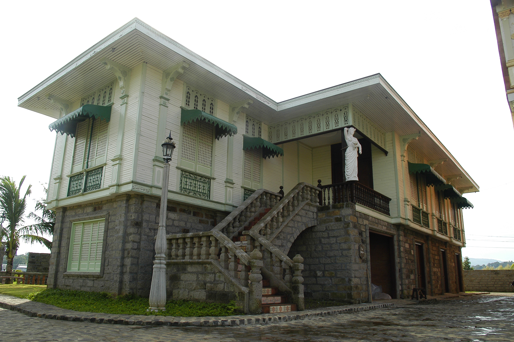 a building with a statue on the porch