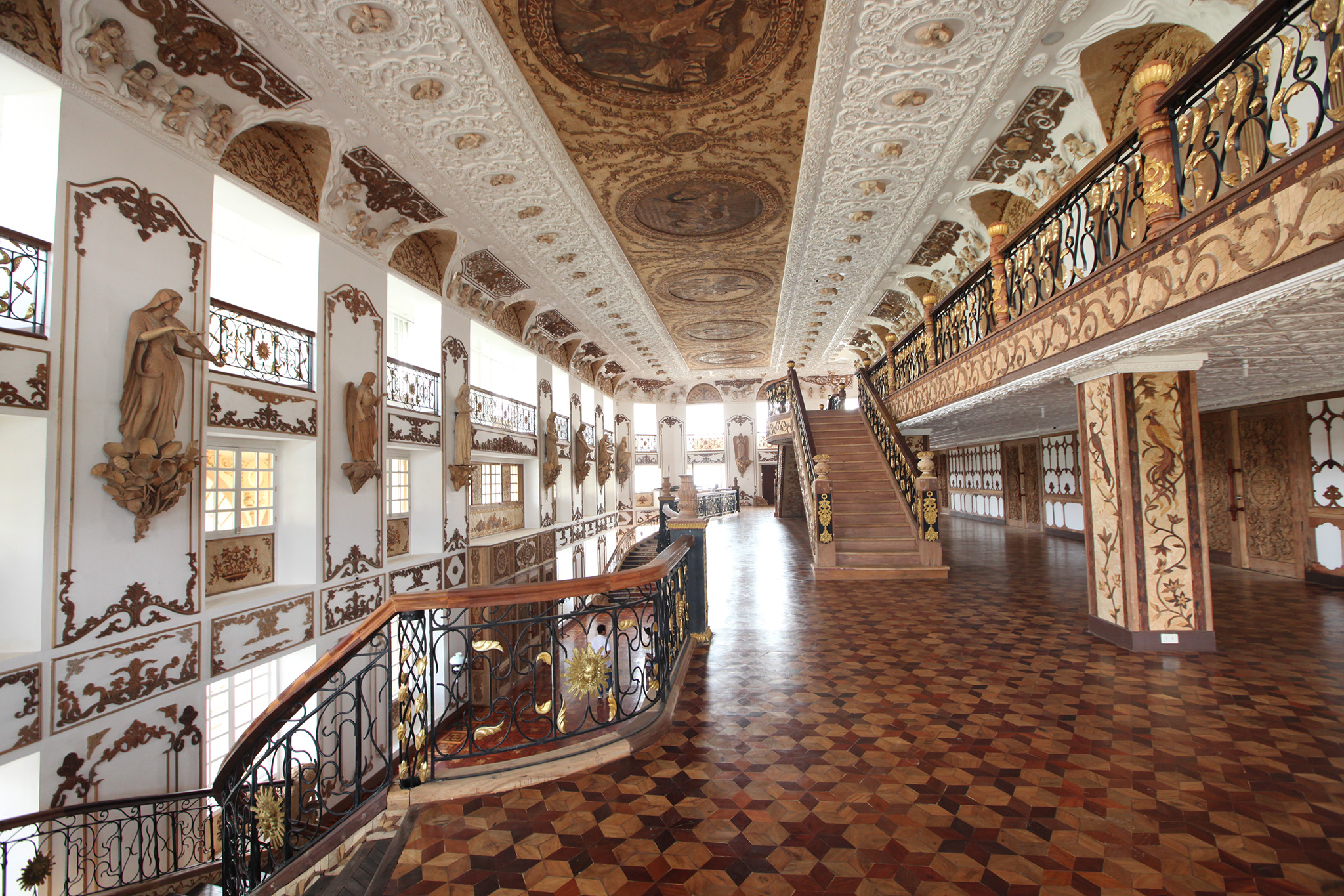 a large ornate building with a staircase and art work