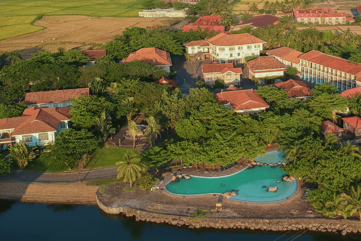 a pool and houses by a body of water